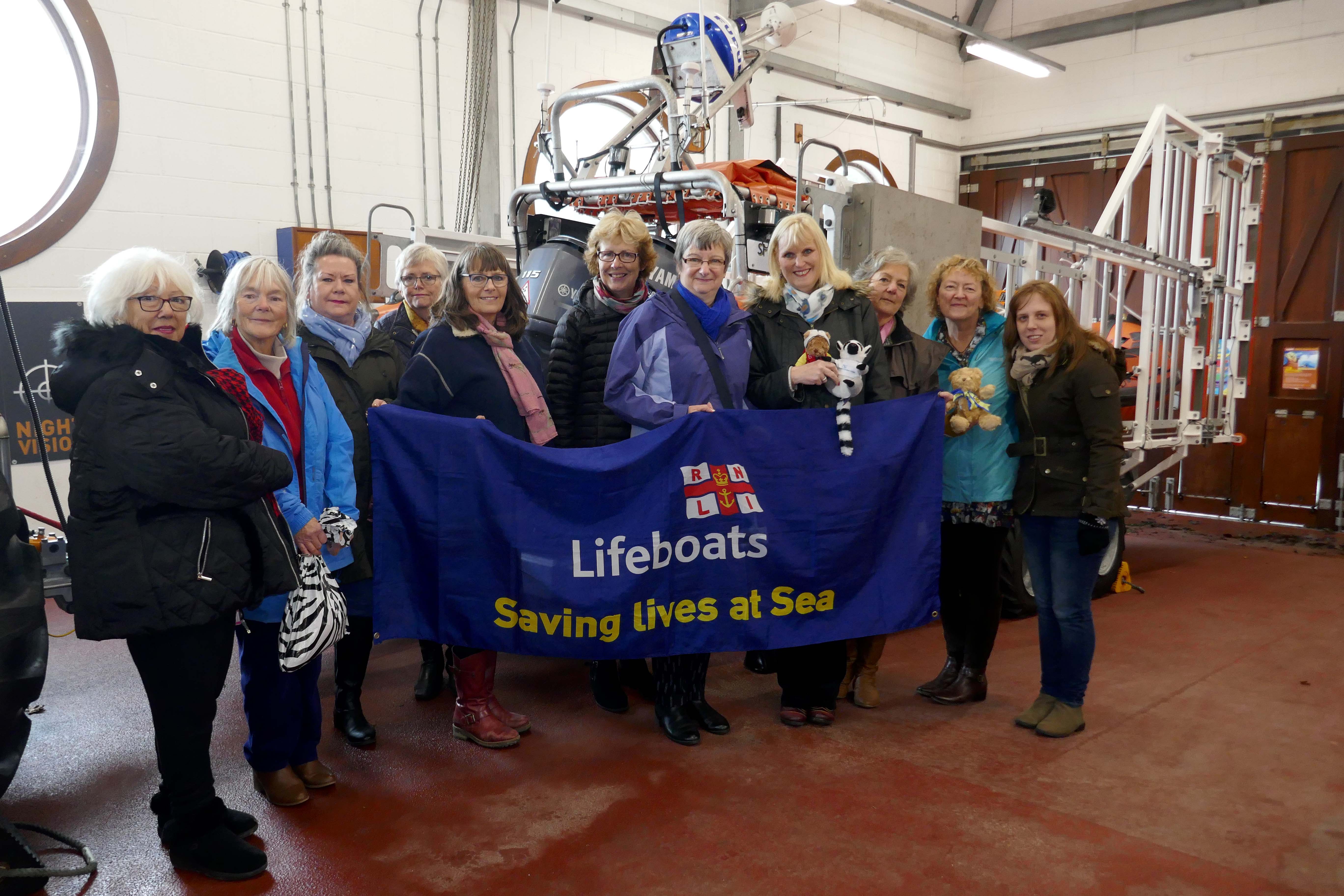 Members of Liskeard and Looe Tangle club and national president Sue Hill beside Looe RNLI’s Atlantic 85 inshore lifeboat Sheila and Dennis Tongue II