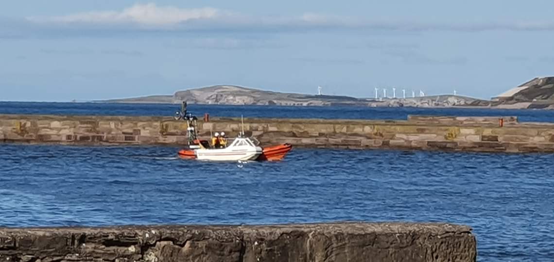 St Bees lifeboat towing the fishing boat into the Harbour.