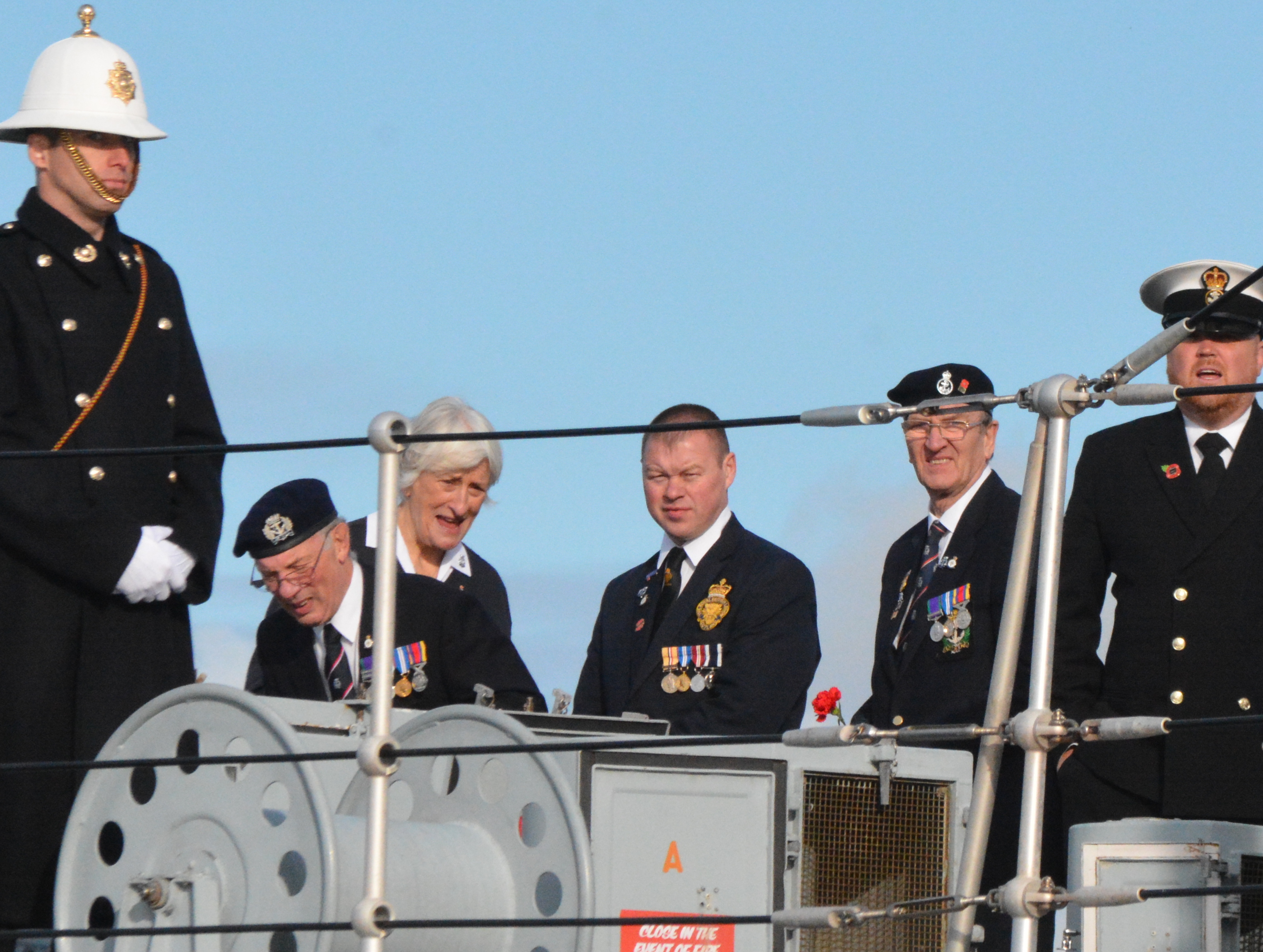 Ships company and visitors at attention during service