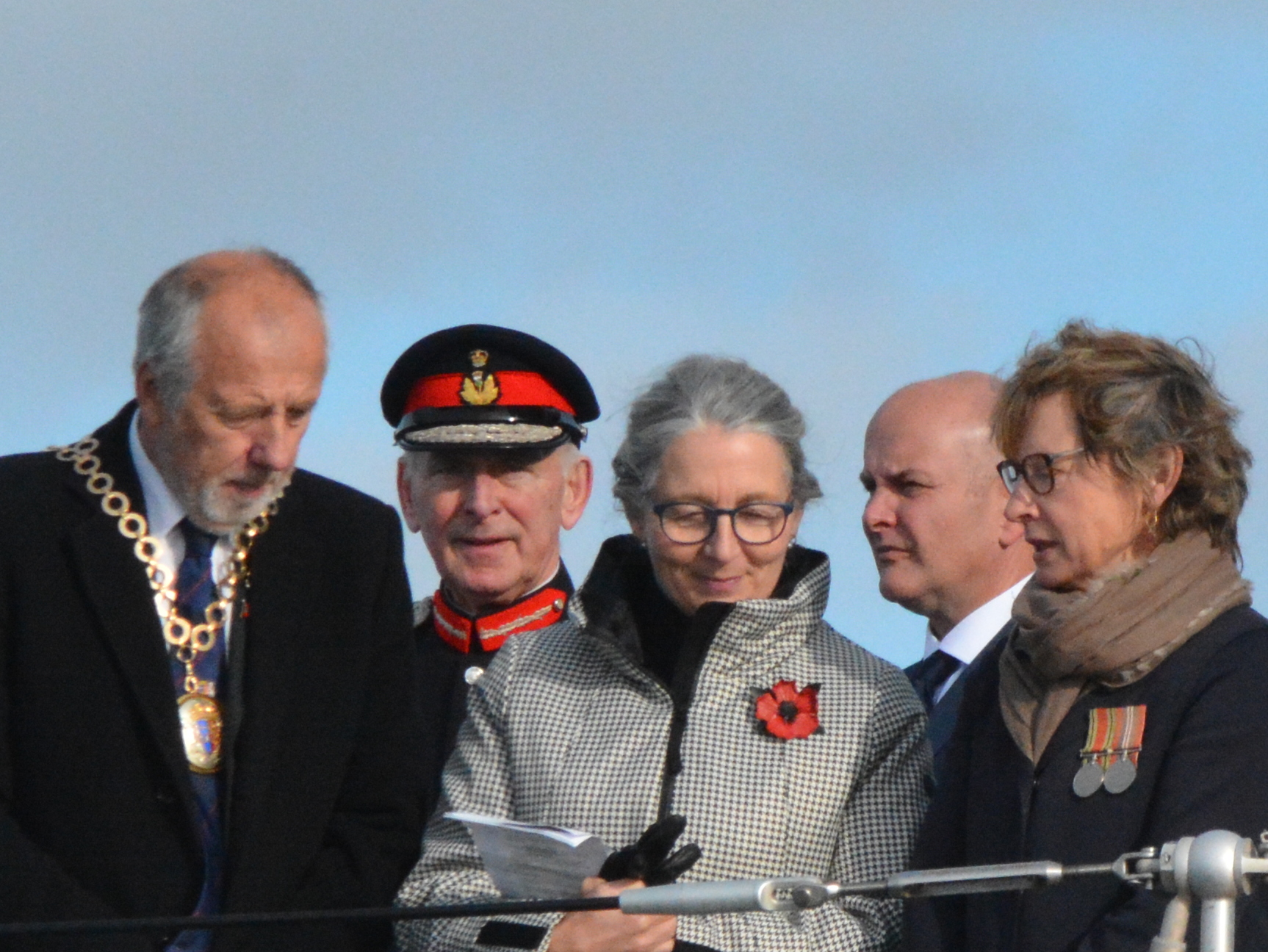 Ceremony attendees talking after the service on HMS Bangor