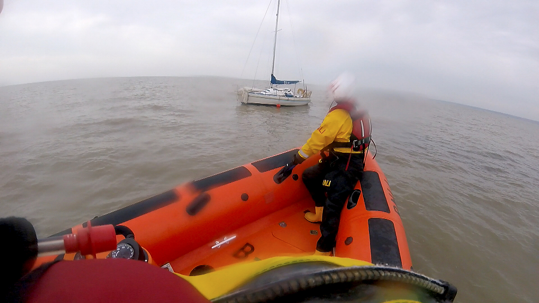 The Whitstable Atlantic 85 Lifeboat Lewisco comes alongside a 23-foot yacht after the craft went aground on a bank in the entrance to the Swale on 23rd October . Picture:RNLI Whitstable.
