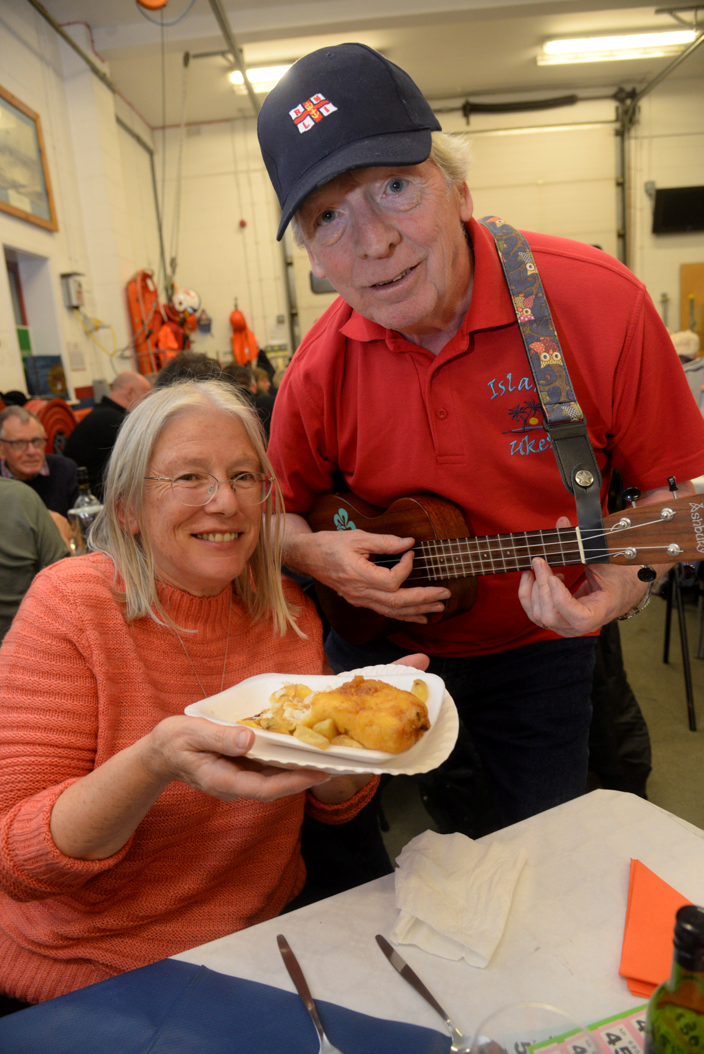 Derek Clinick of Island Ukes serenades Liz Yems at the Whitstable lifeboat station 'fish and chip' evening on Friday. Picture:RNLI Whitstable