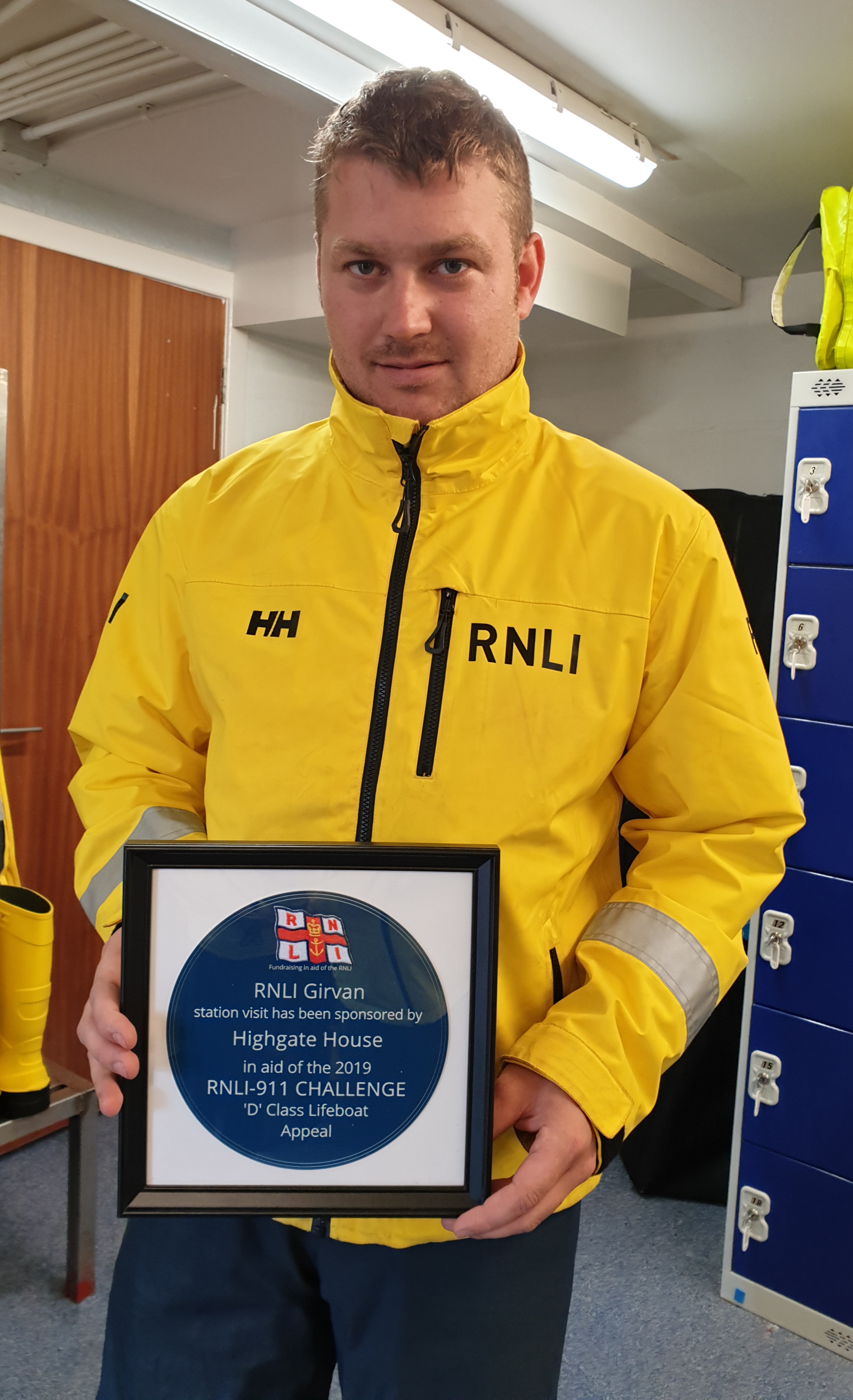 Callum with the plaque presented to the station commemorating their visit and sponsorship of the station on this leg by Highgate House