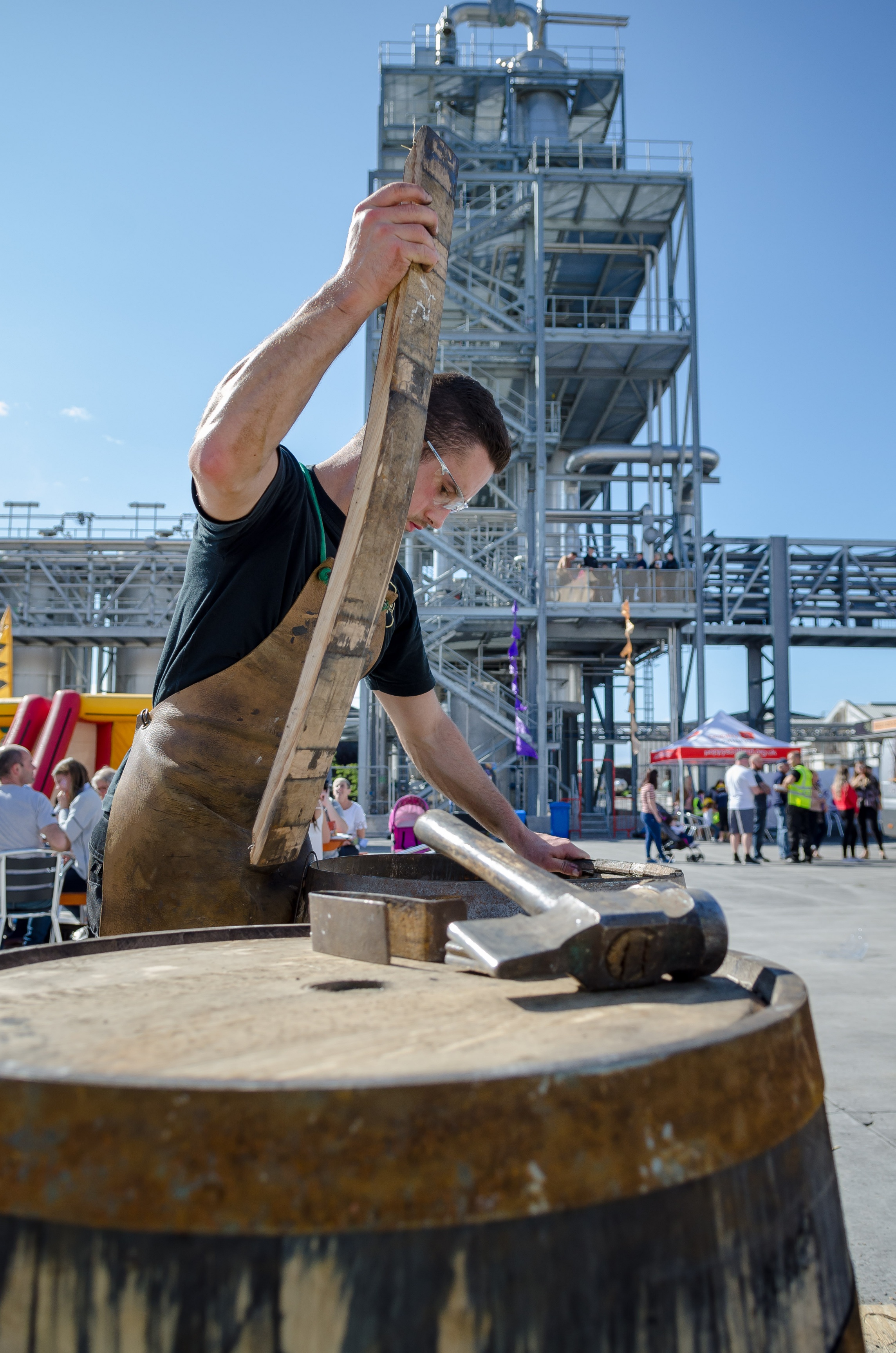Cooper and crewmember Fraser Stirling at work repairing barrels at William Grant &amp; Sons Distillery.