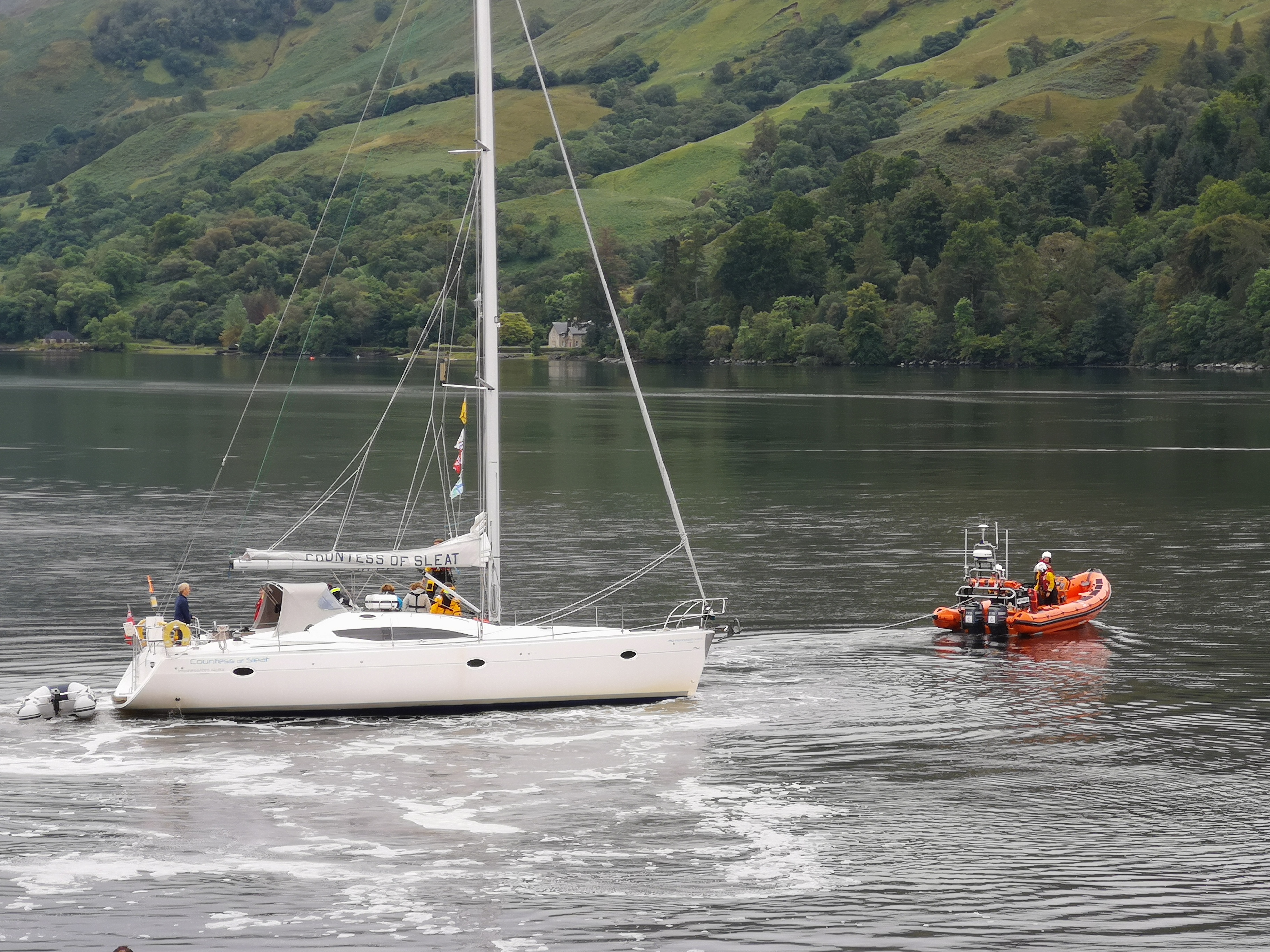 Yacht under tow after coming off the rock