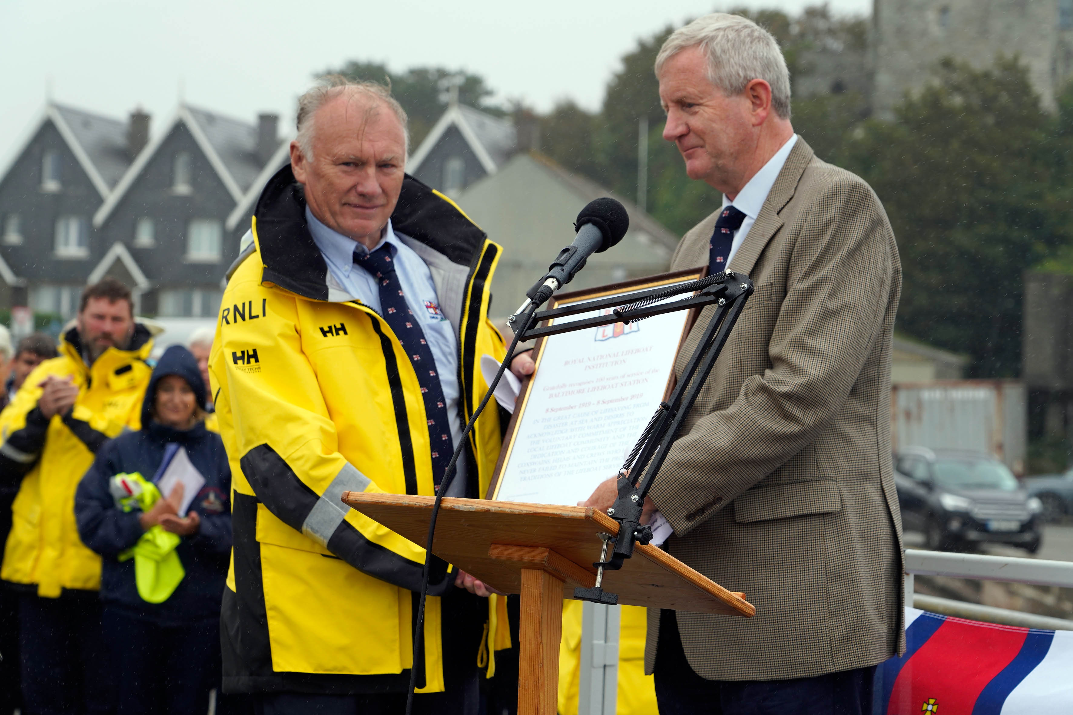 Coxswain Kieran Cotter receives the station centenary vellum