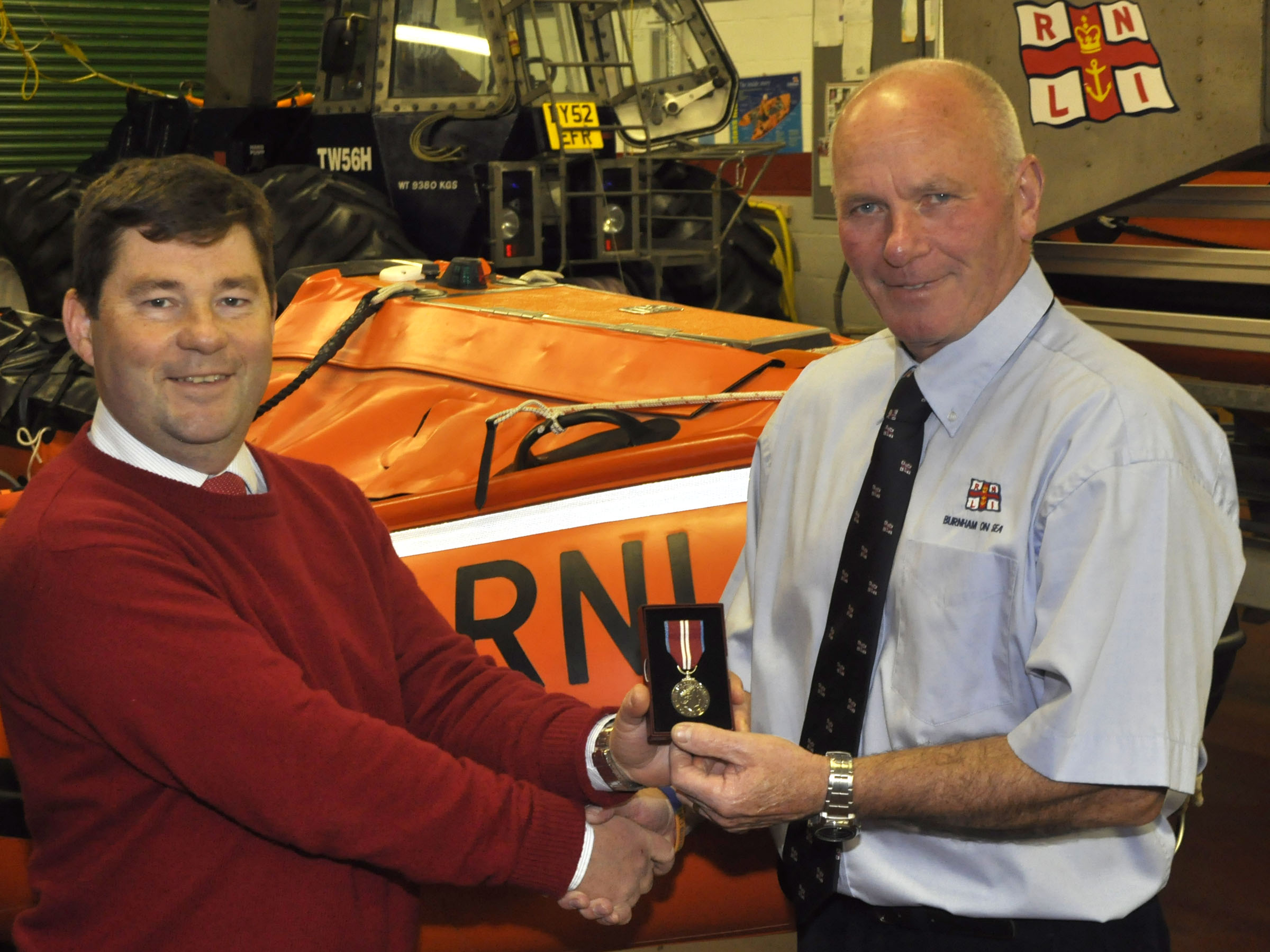 A past image of Dave Parsons accepting his Jubilee medal from RNLI inspector Nigel Jones