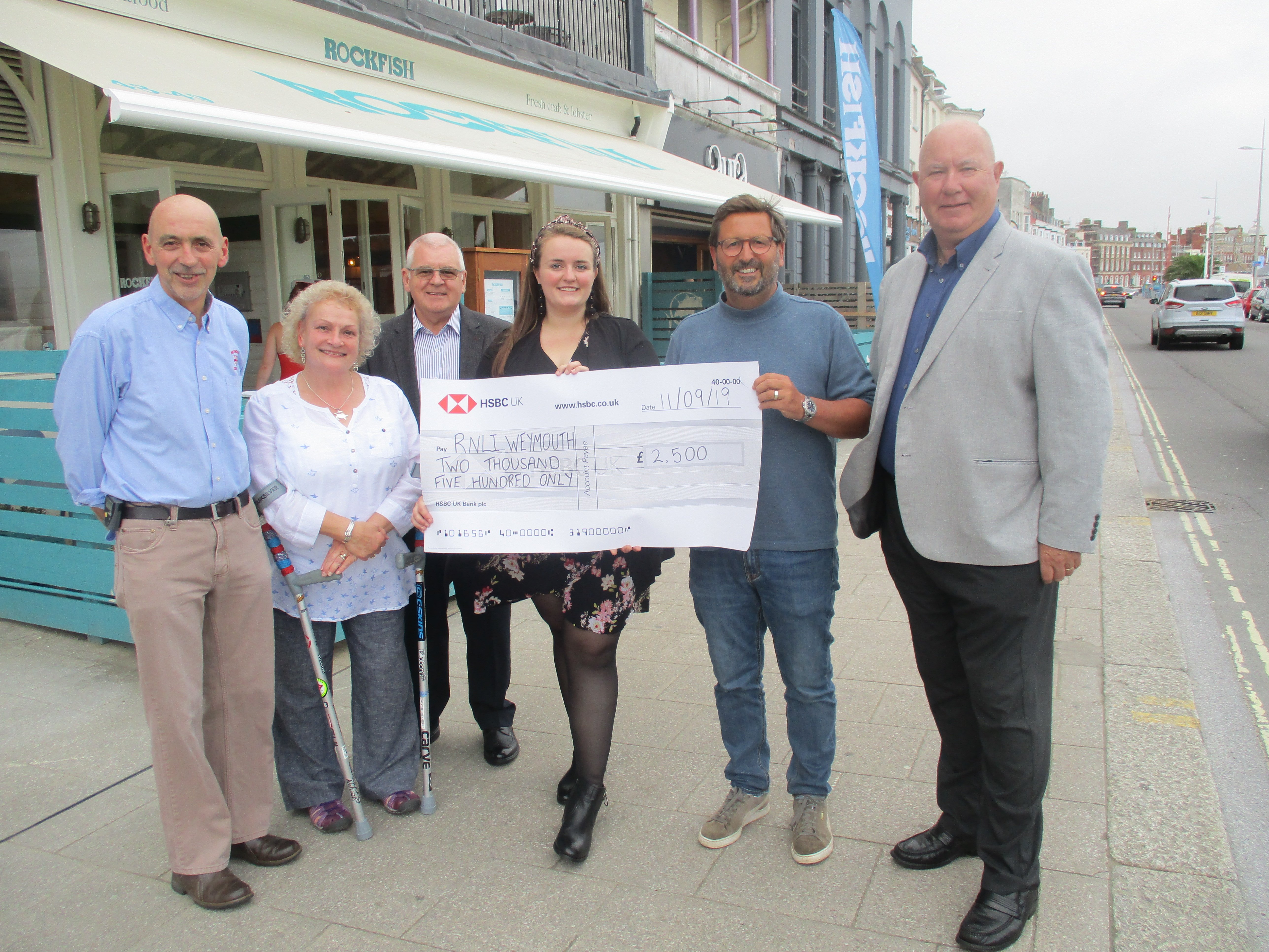 L to R - Weymouth RNLI Coxswain Andy Sargent, Lifeboat station Treasurer Jo Birch, Lifeboat station Archivist Alan Birch, Rockfish General Manager Kate Raven, Rockfish Restaurateur Mitch Tonks, Lifeboat station press officer Ken Francis
