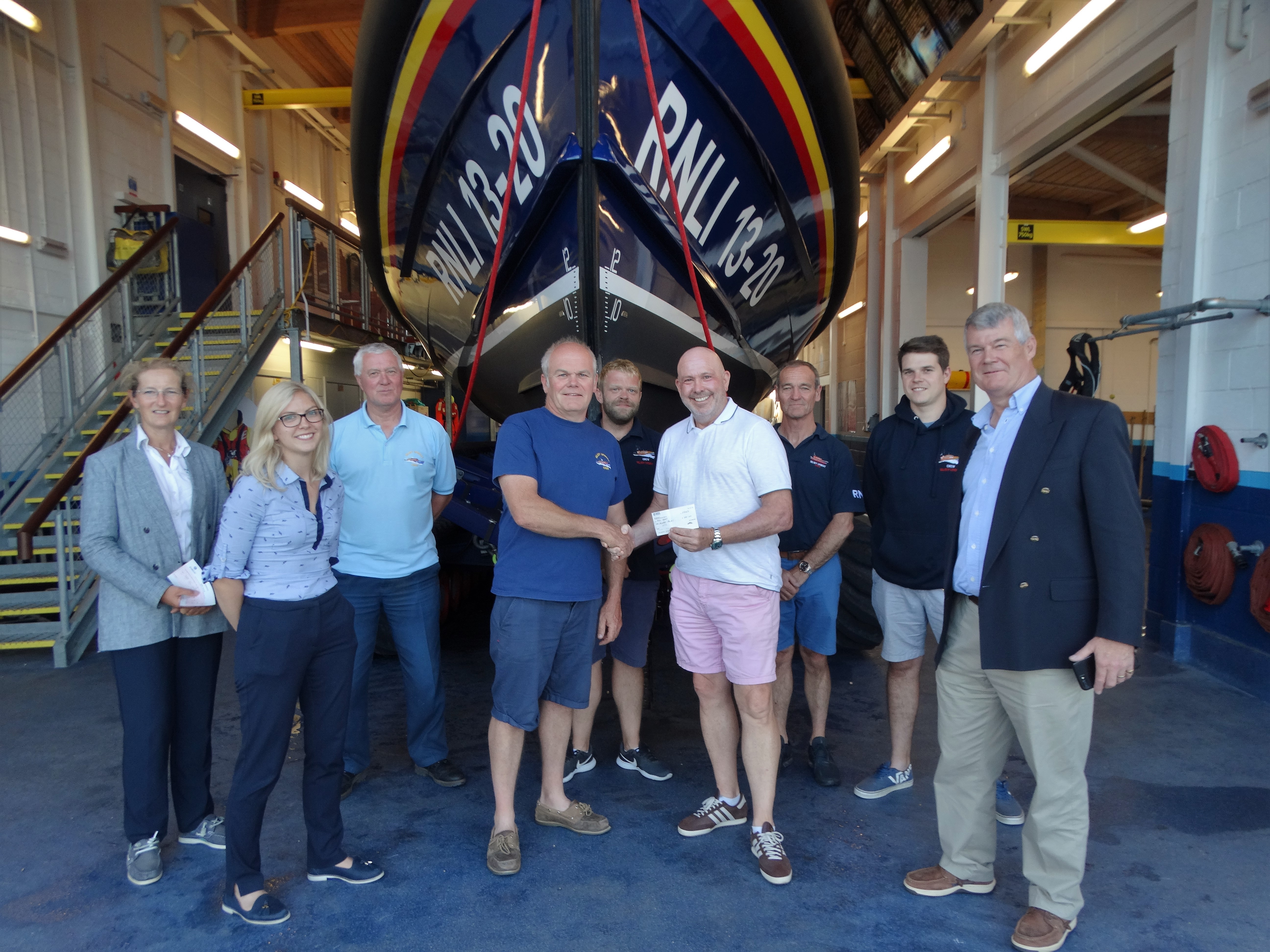 Harry Close presenting cheque to deputy 2nd coxswain