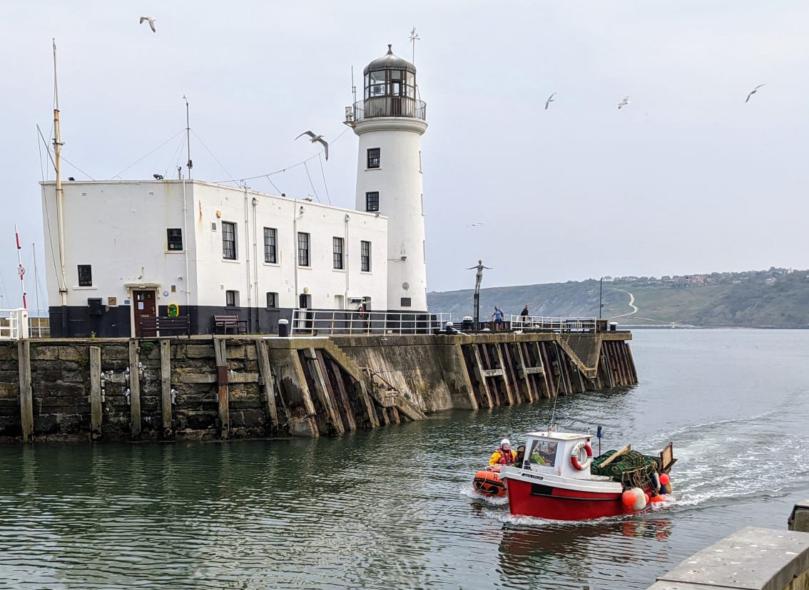 The lifeboat on the other side of the fishing boat