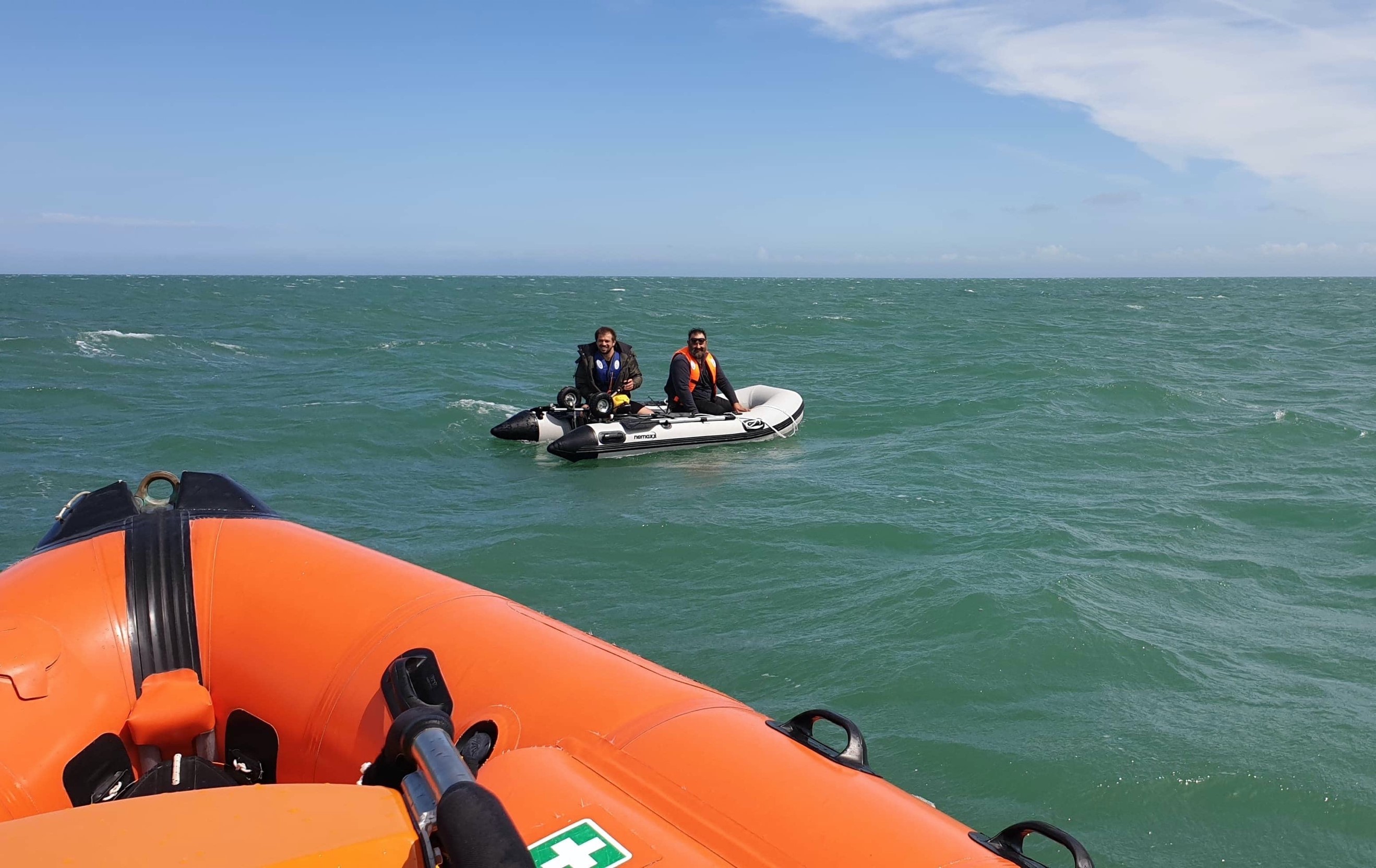The lifeboat arrives on the scene to help the two fishermen.