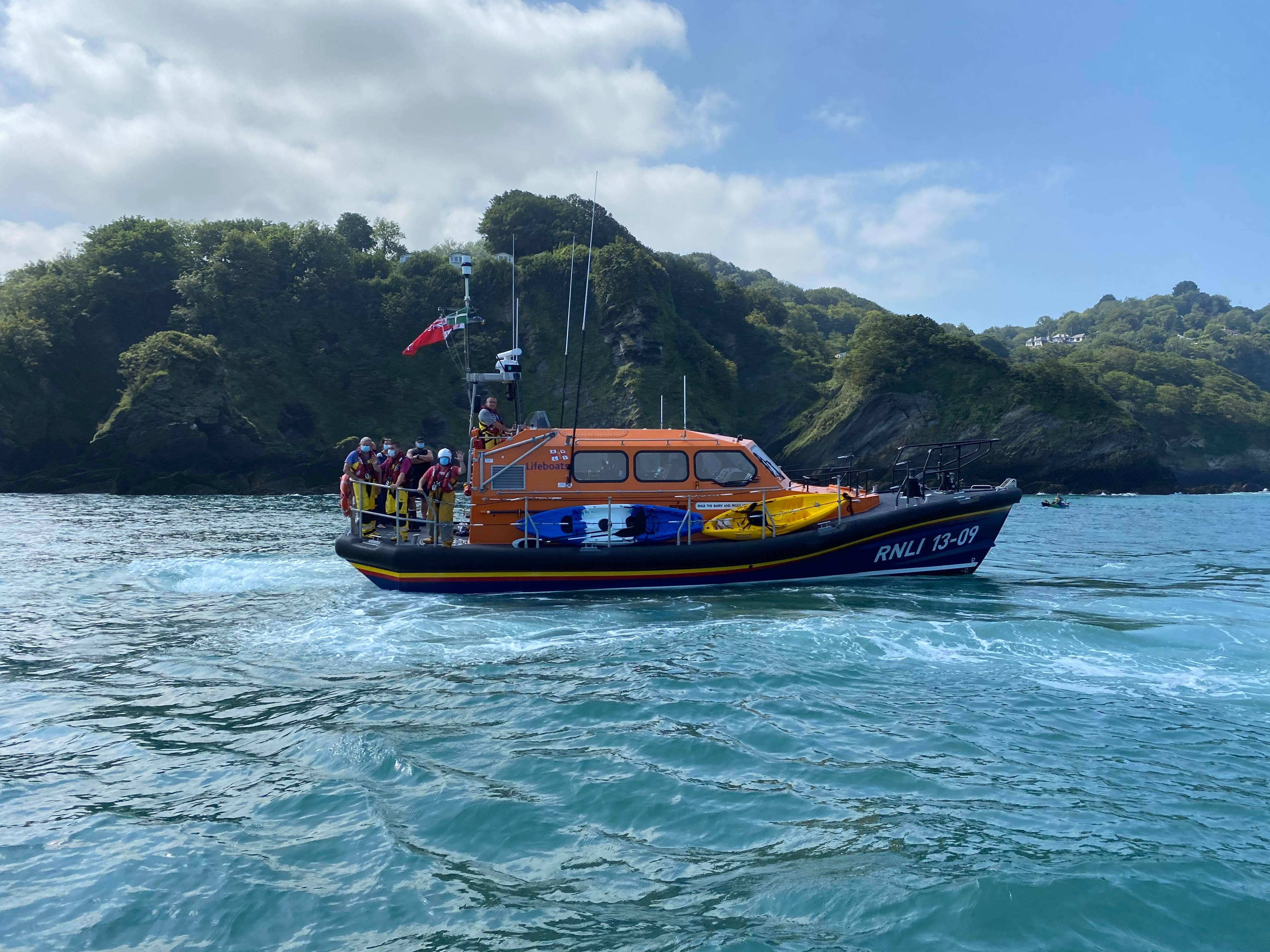 Ilfracombe all-weather lifeboat with crew and casualties aboard at Combe Martin Bay