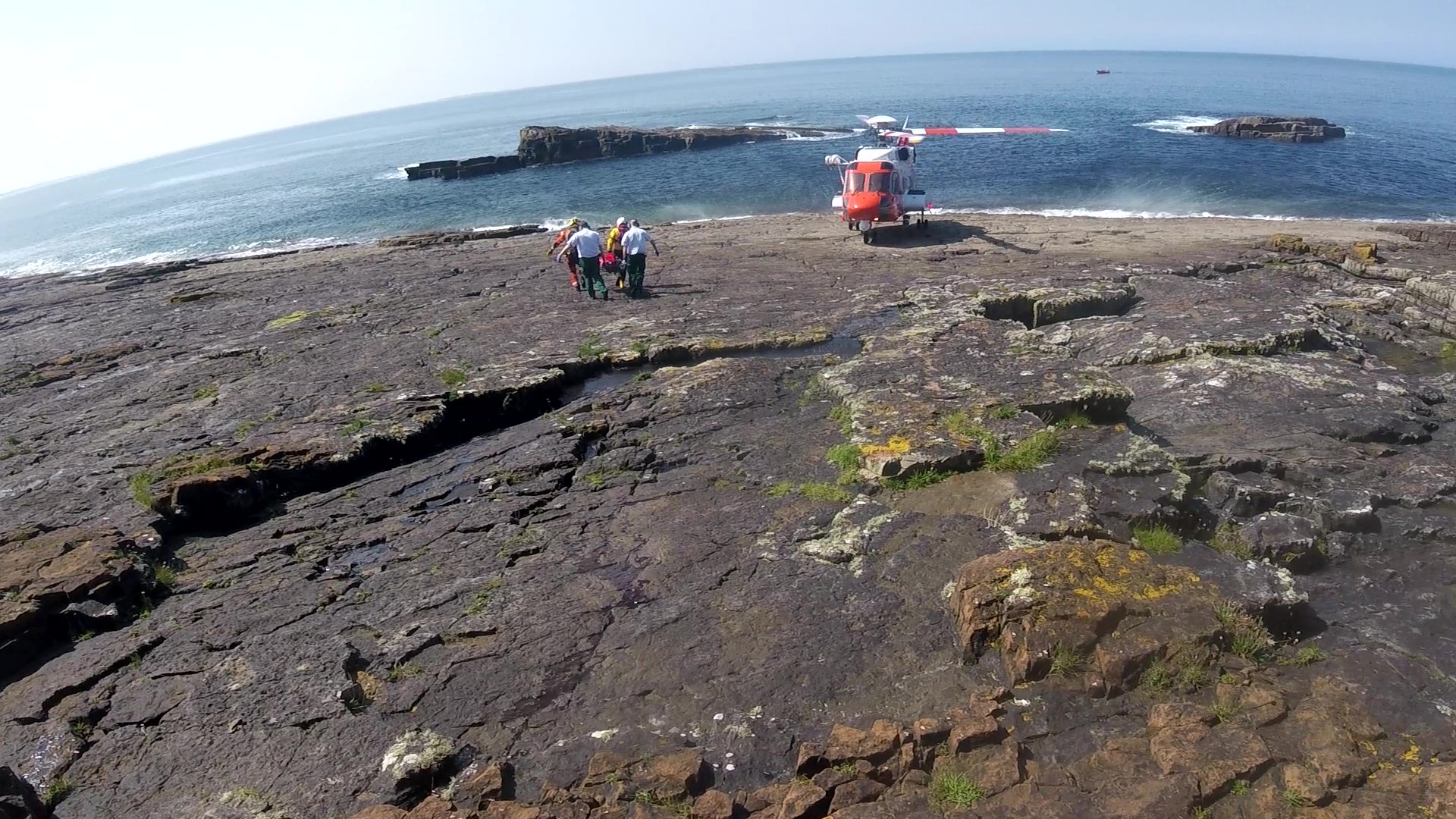 Photo shows casualty being carried by stretcher to the awaiting Rescue 118 helicopter