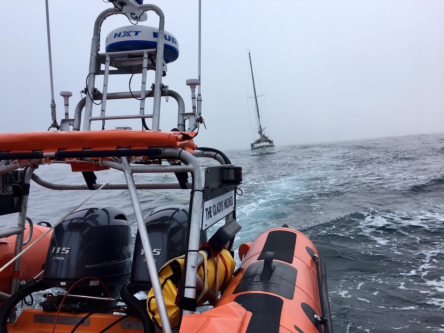 View from the stern of Newquay lifeboat as yacht is towed to safety in foggy conditions