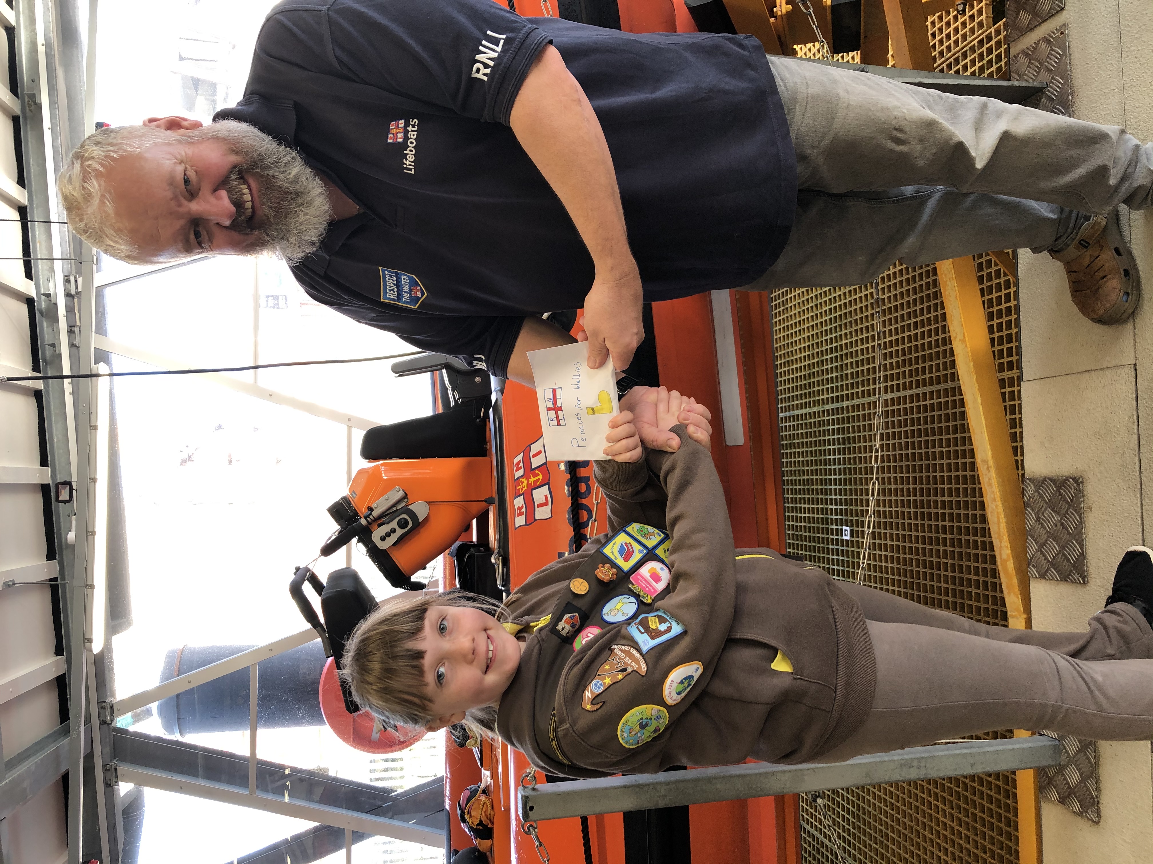 Izzy presenting her pennies to Helm Jonathan