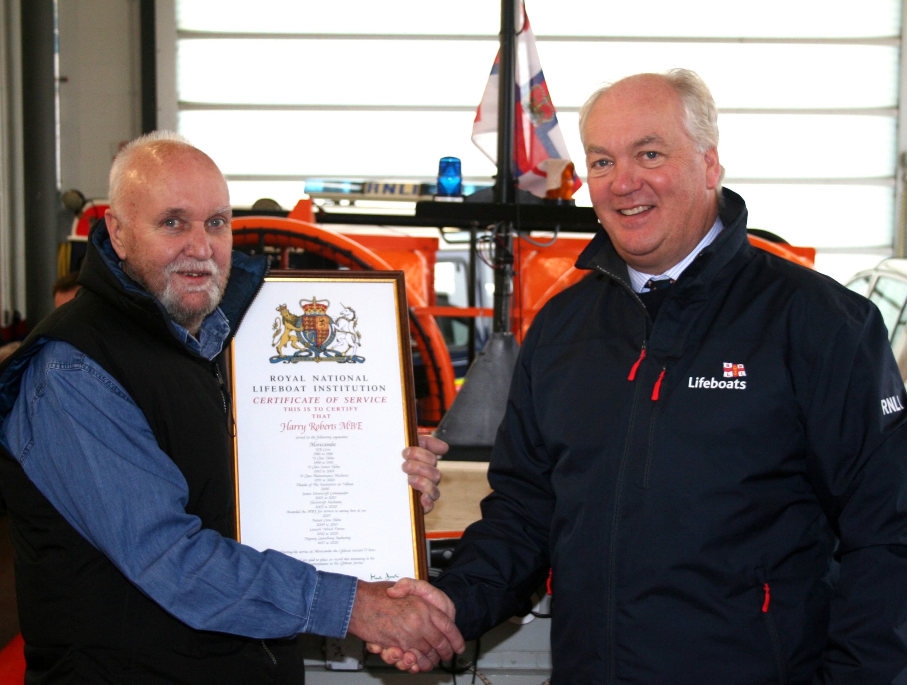 RNLI CEO Mark Dowie presents long service certificate to Harry Roberts MBE after 34 years RNLI volunteer service