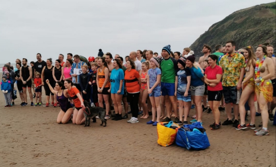 Swimmers posing for a team photo before the dip.