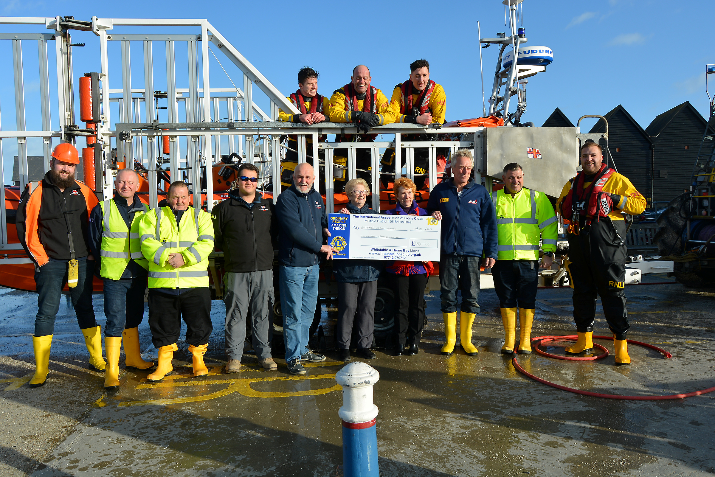 Maureen Warn and Fiona Page of the Whitstable &amp; Herne Bay Lions Club present the cheque for £250 to members of the Whitstable Lifeboat Station just before Christmas. Picture: Lesley Pepper.