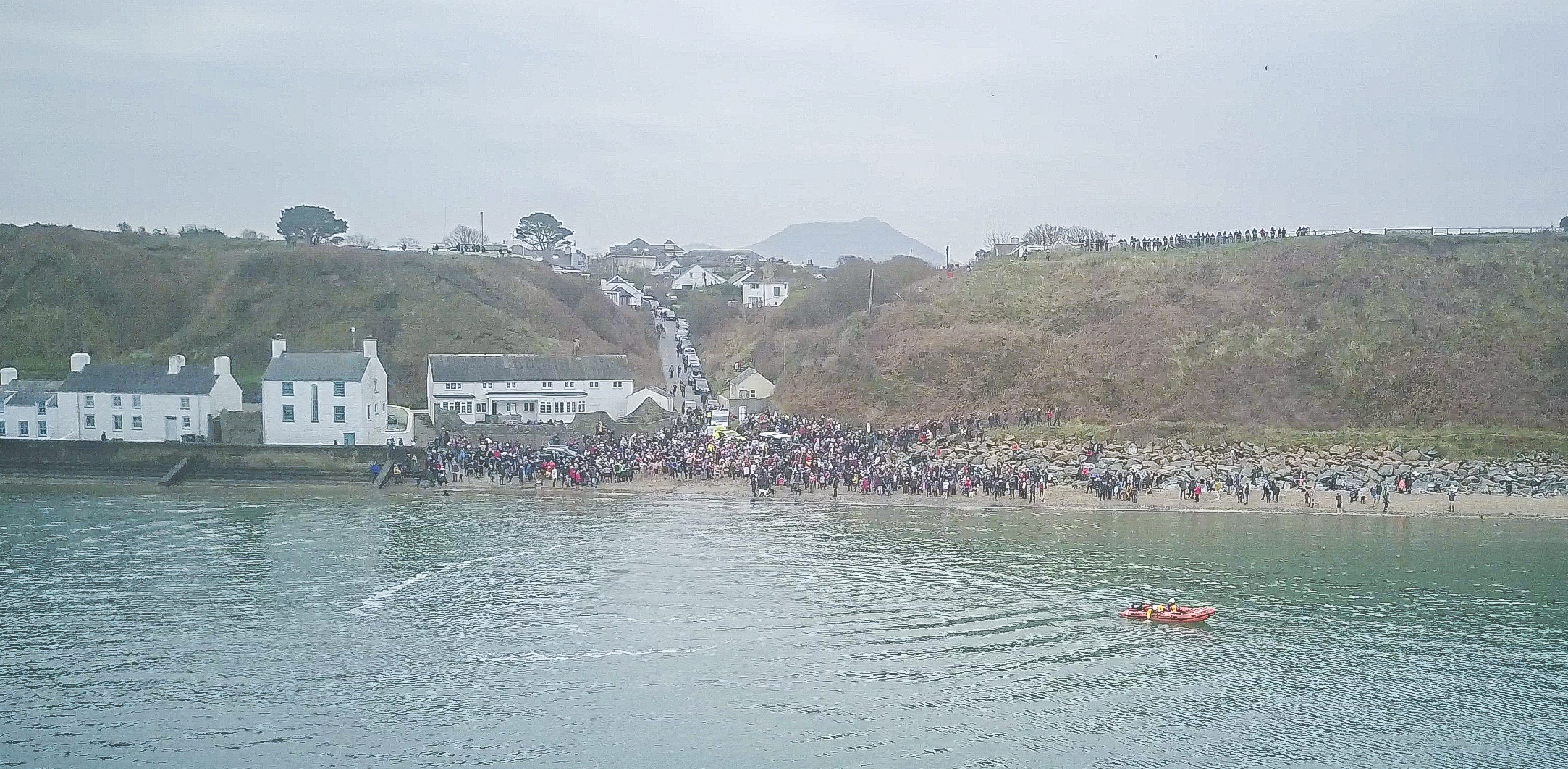 Swimmers prepare themselves to brave the chilly water at Morfa Nefyn bay.