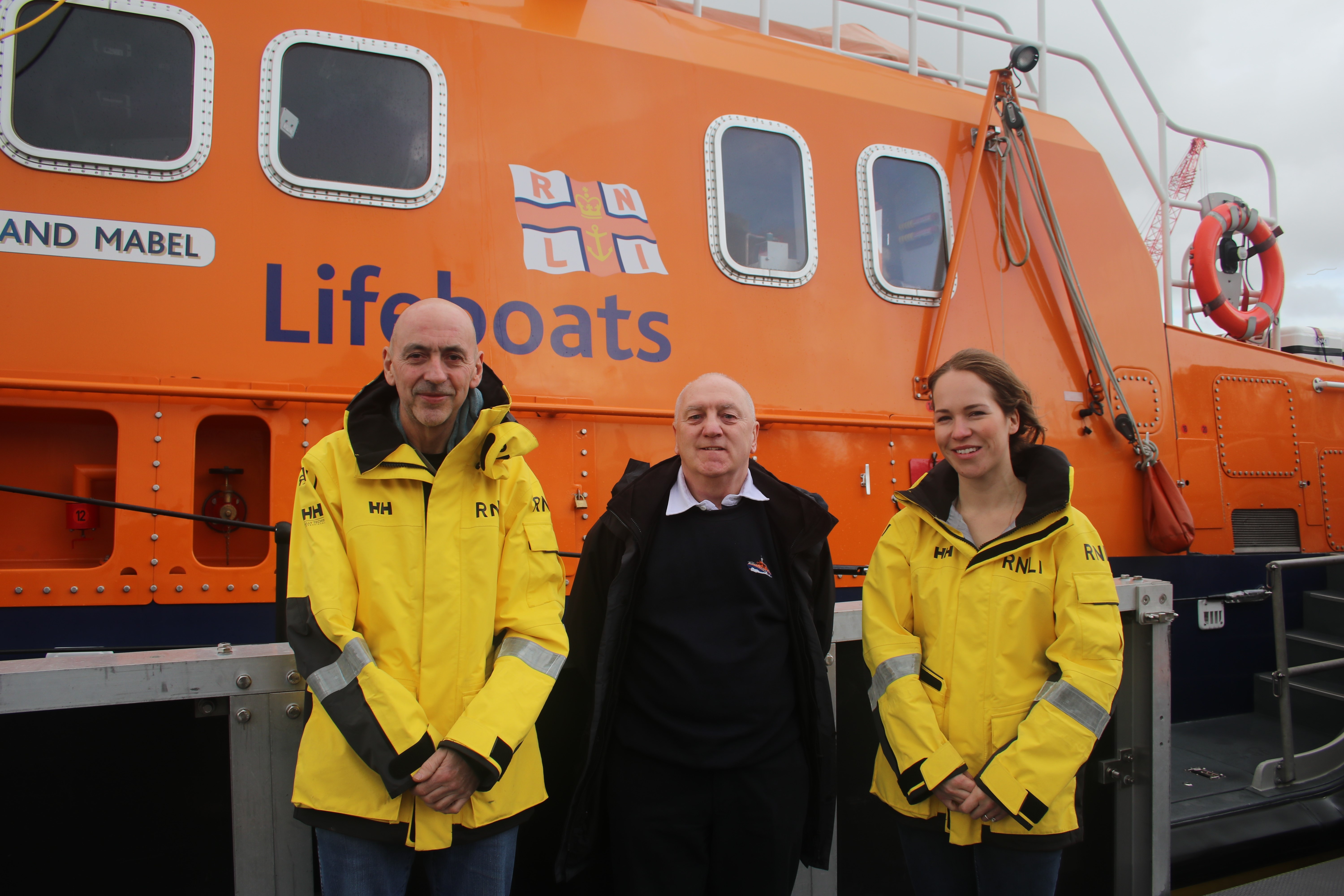 Peter Antram is flanked by Coxsain Andy Sargent and LOM Nicki Ayling