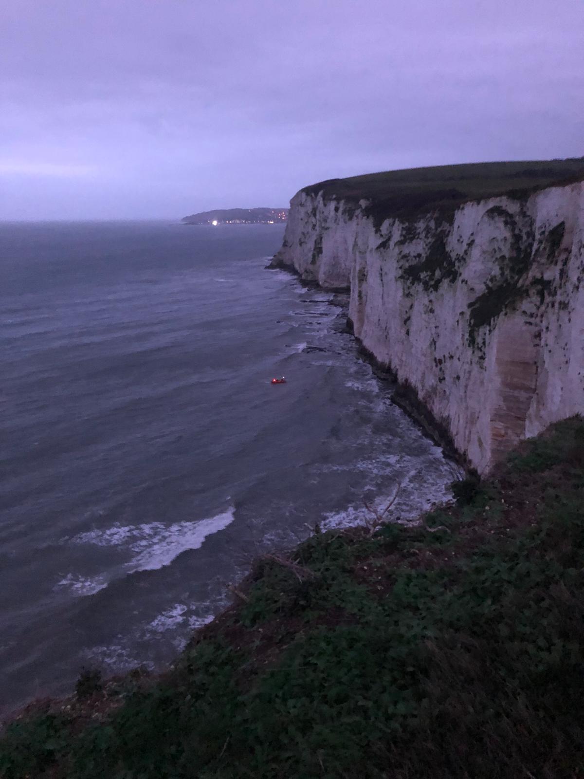 Swanage inshore lifeboat recovering casualties stranded by the tide.