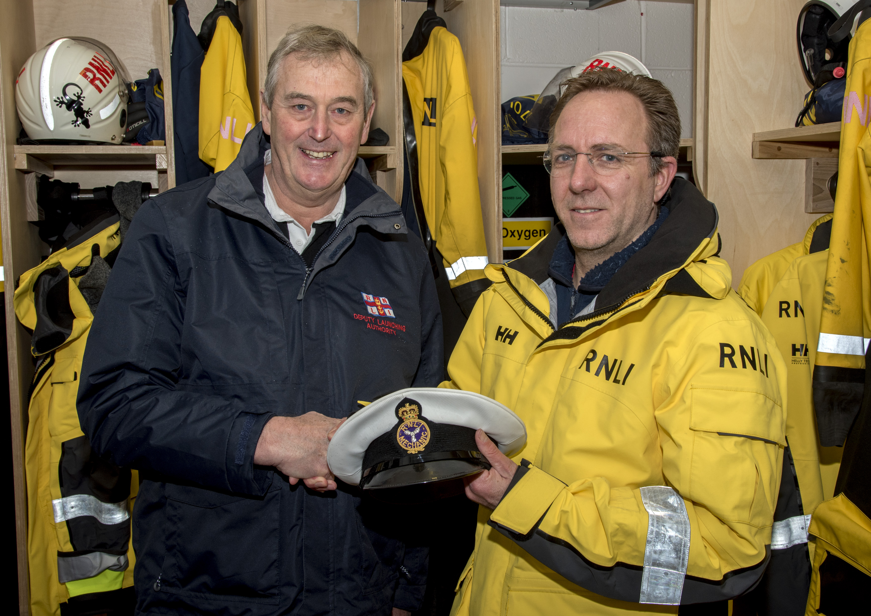 Lifeboat Operations Manager Nick Lewis (left) presenting Jonathan Hackwell with his RNLI mechanics cap