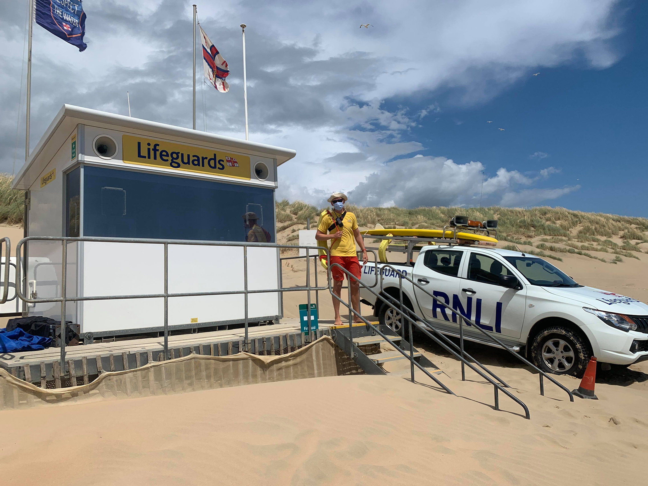 Photo of RNLI lifeguard James Blything on the beach.
