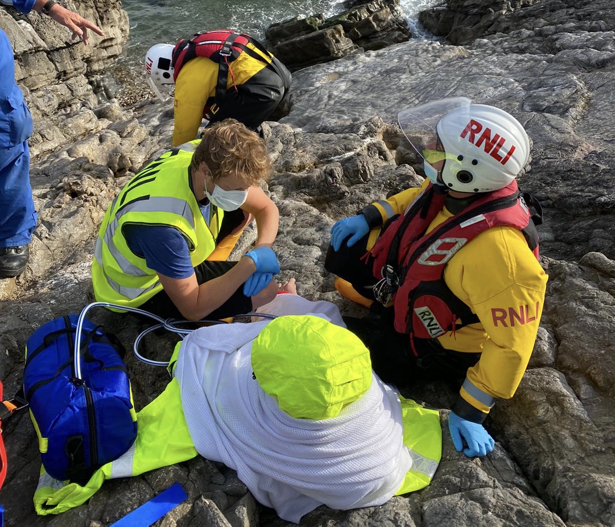 3 crew members assist casualty on the cliff face
