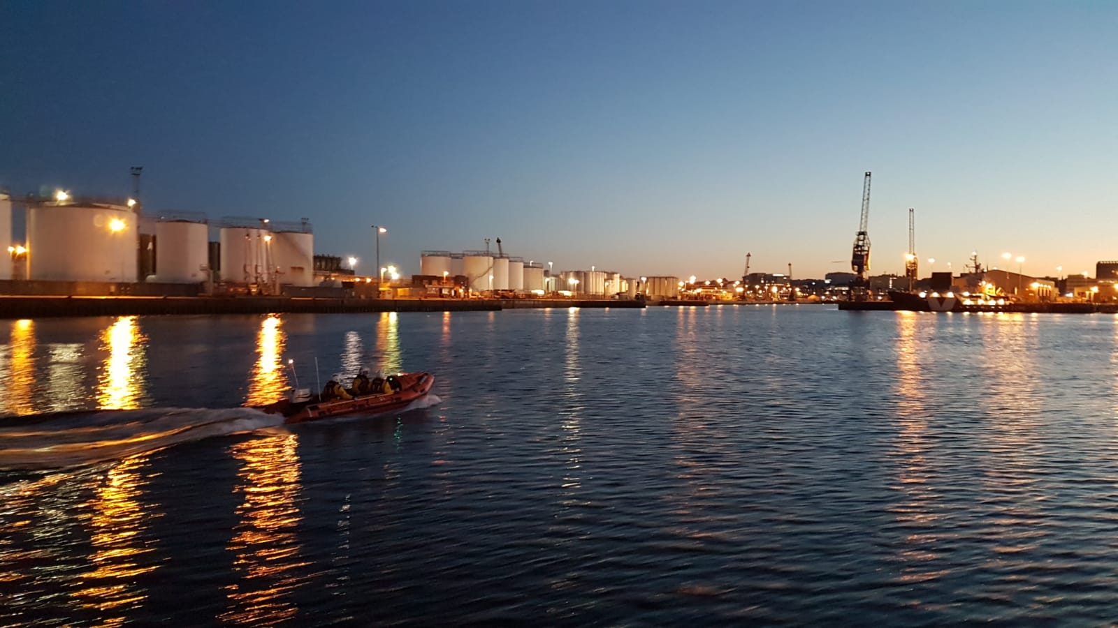 Photographed from ‘Bon Accord’, the D-class ‘Buoy Woody 85N’ leads the way home as the last glow of sunset silhouettes the city of Aberdeen