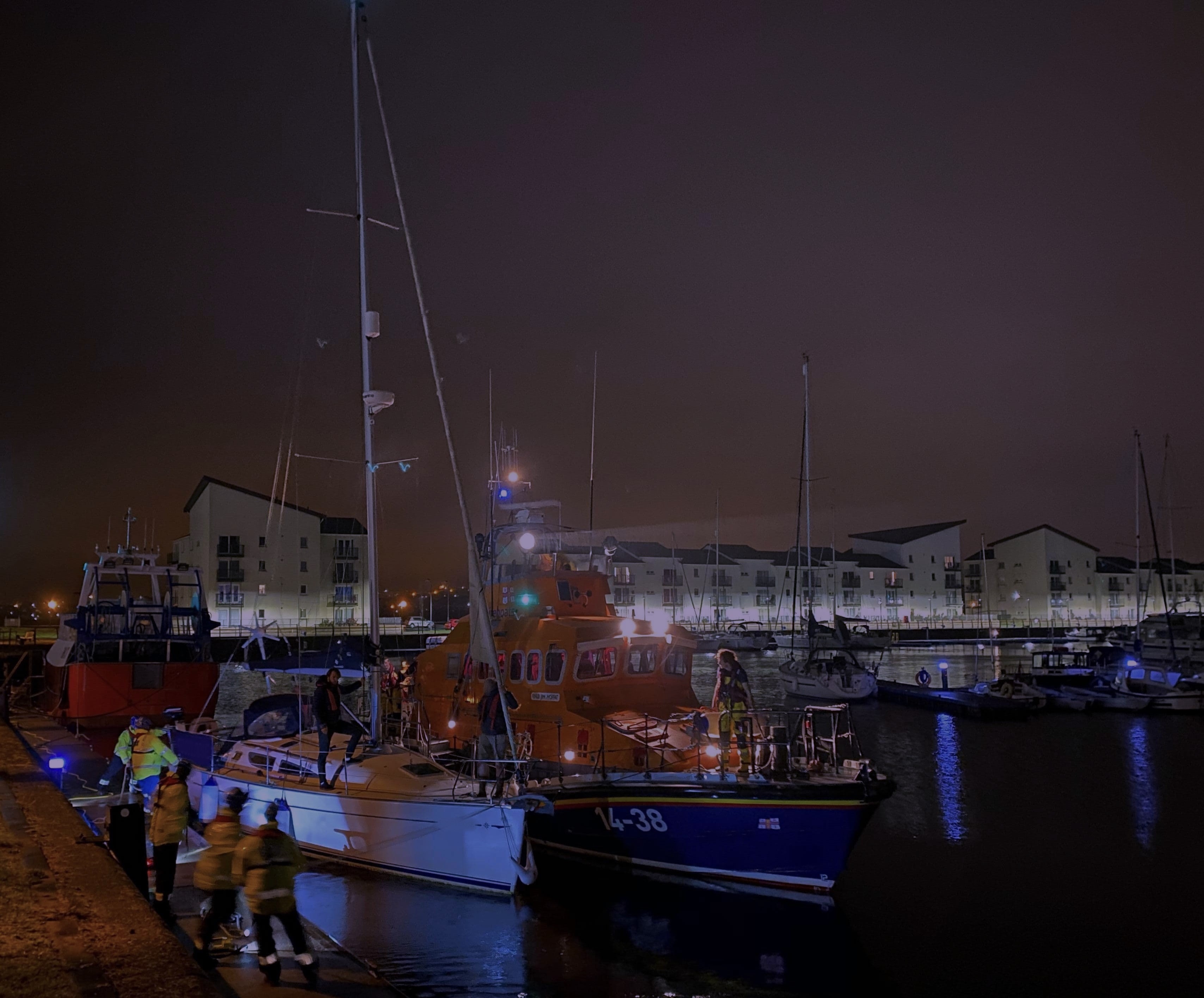 Troon RNLI lifeboat and the vessel alongside in Ardrossan Marina