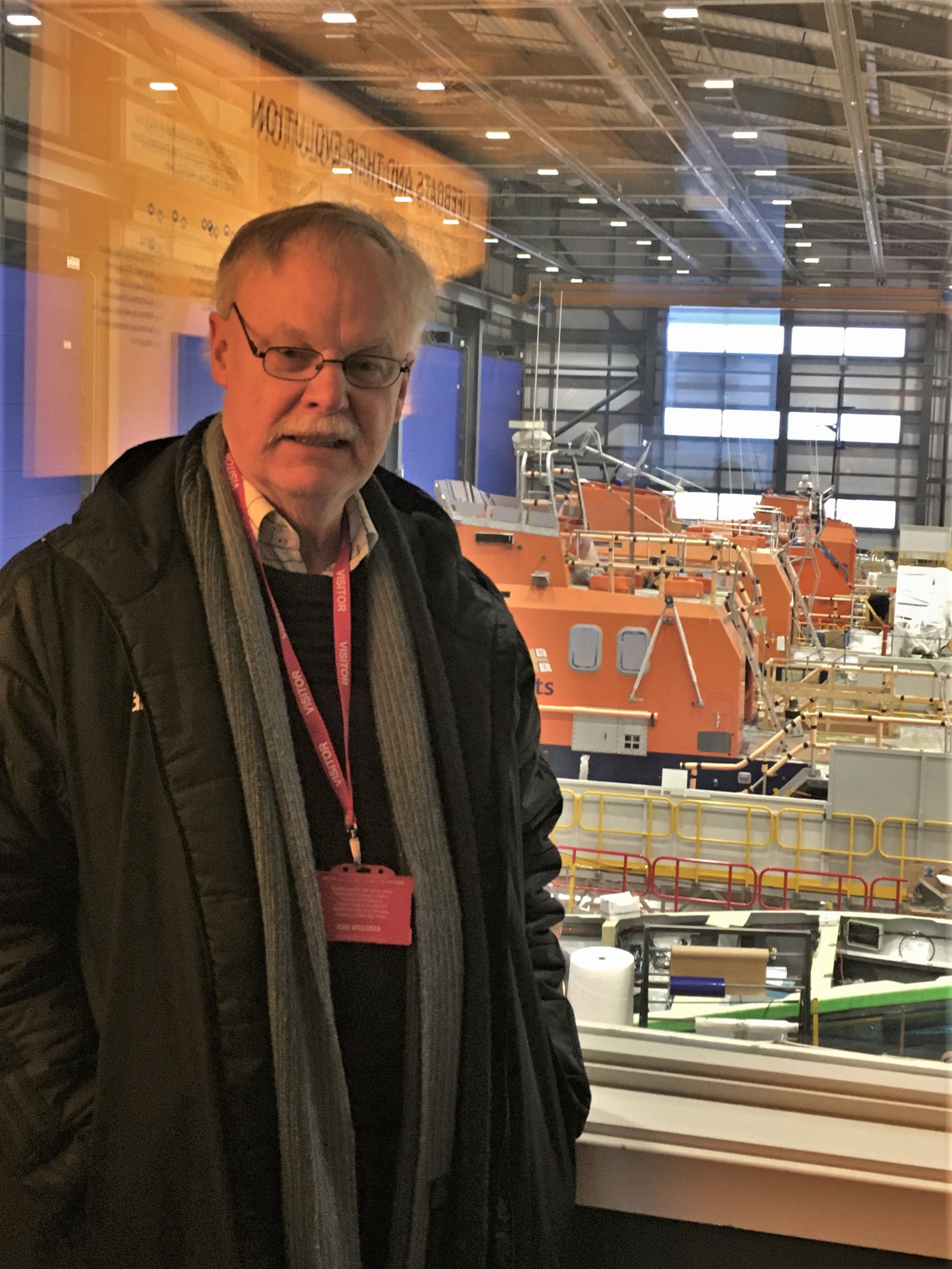 Author David with lifeboat workshops in the background