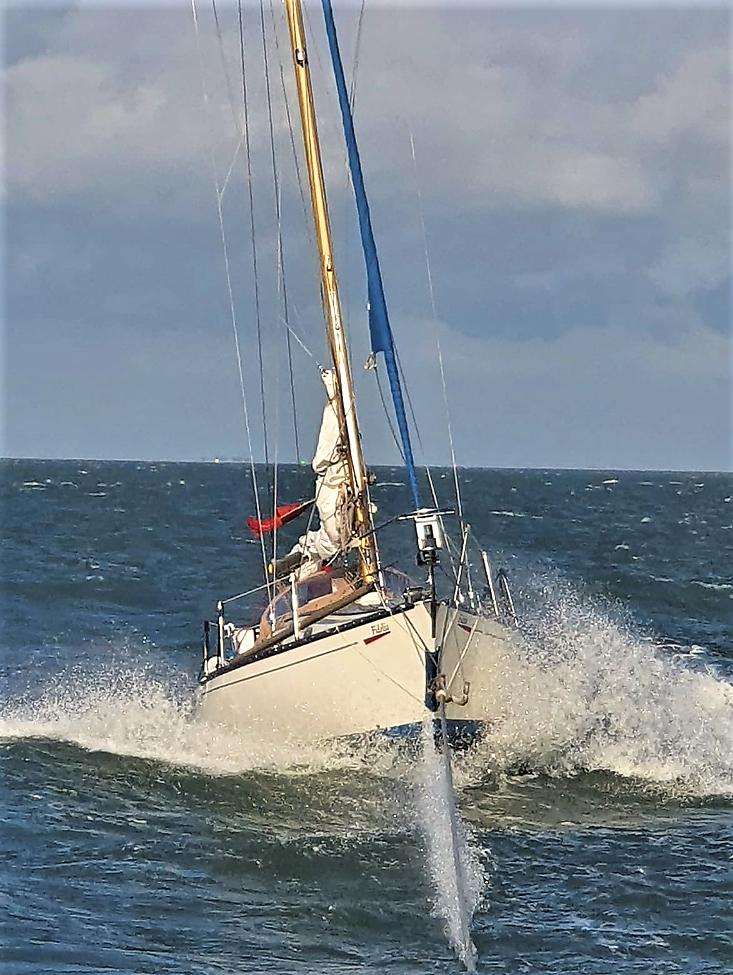 The yacht is taken under tow.
