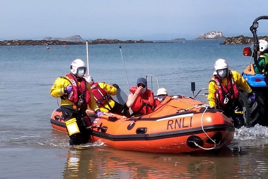 North Berwick Lifeboat with casualties on board, crew wearing facemarks