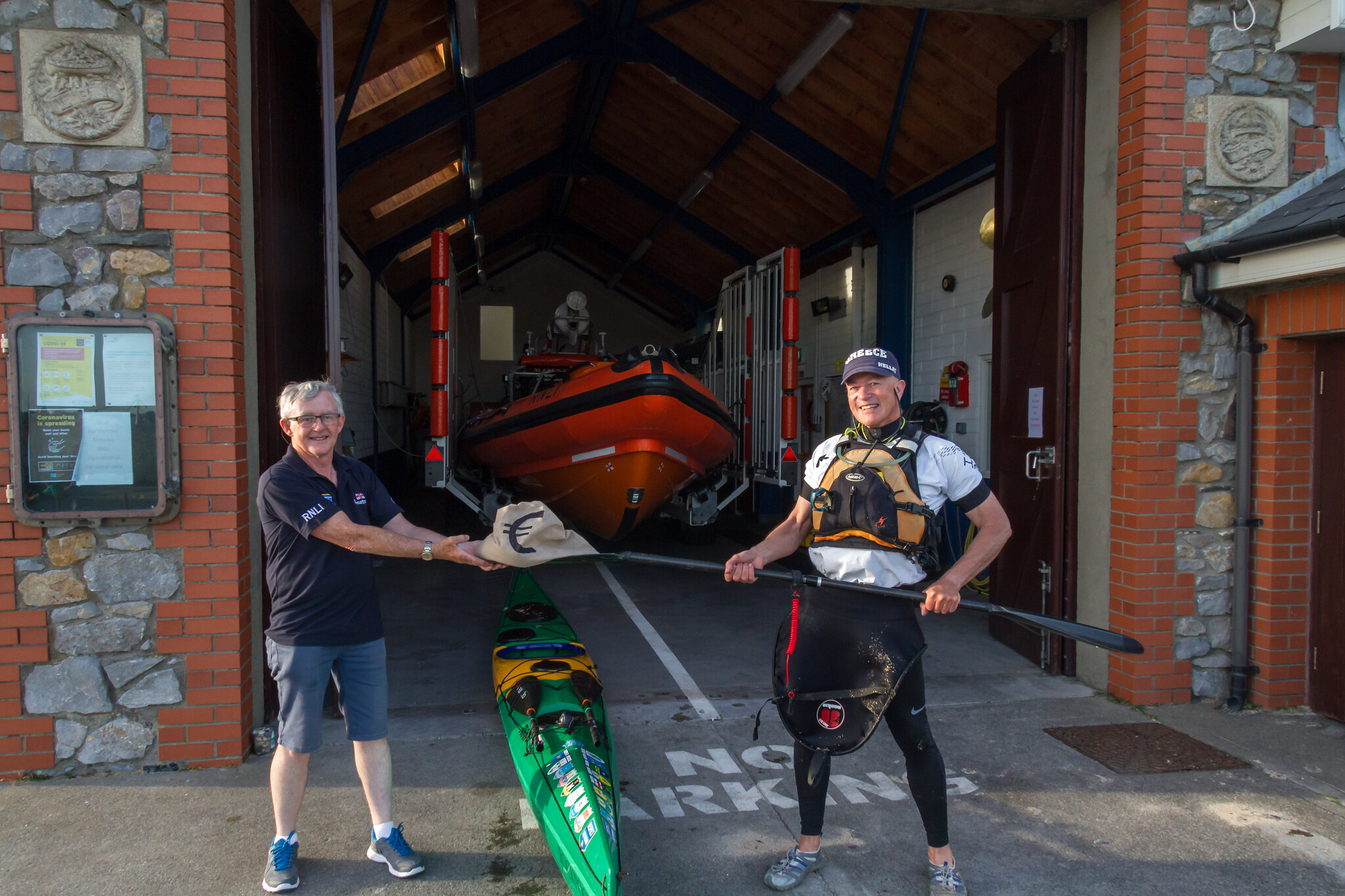 Kevin O’Sullivan using his paddle to pass the “Bag of Swag” while maintaining 2 metres social distancing