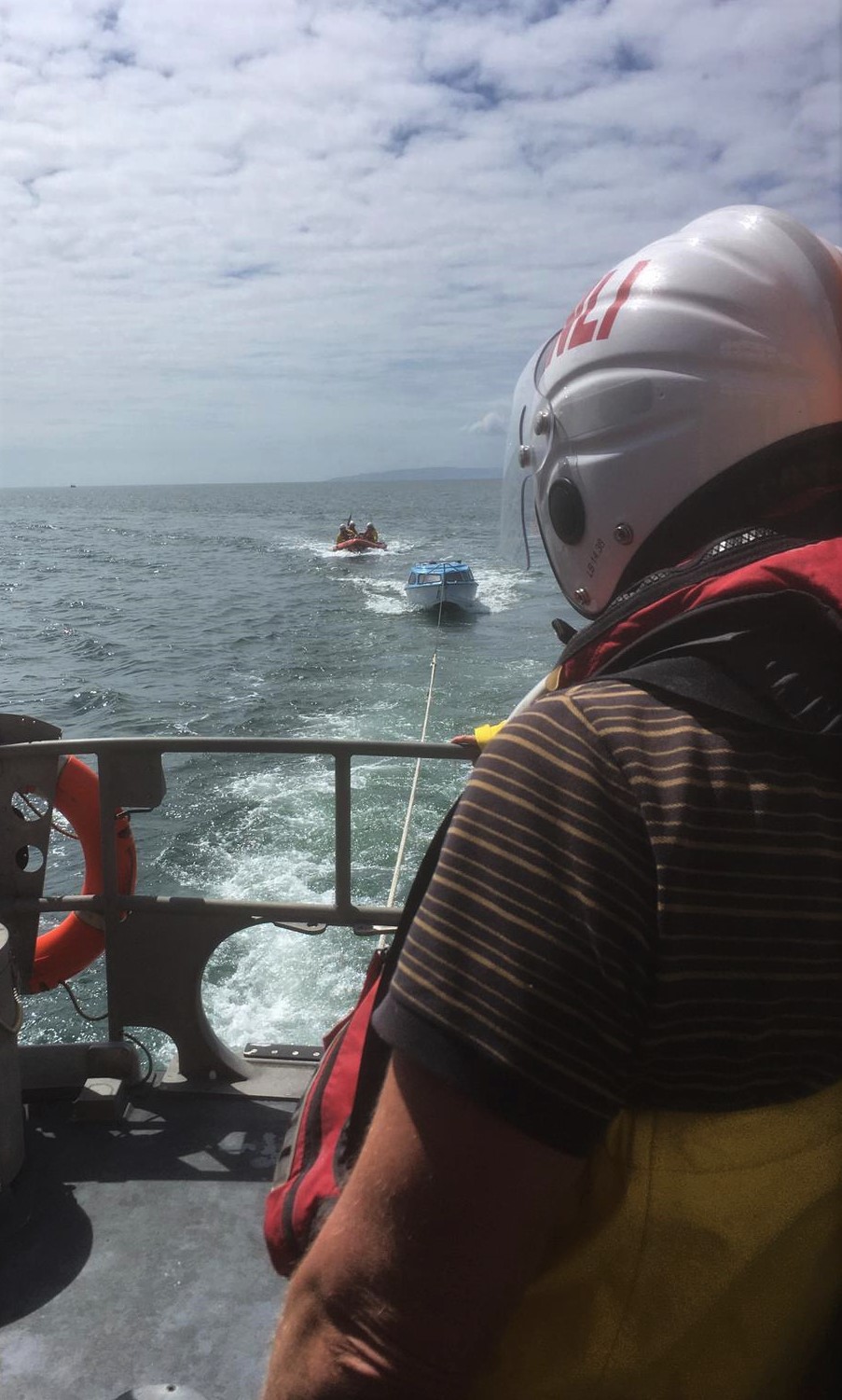 Troon RNLI all-weather lifeboat with the casualty vessel under tow 