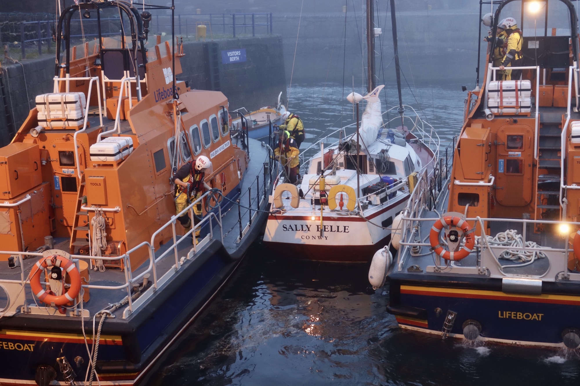 The yacht is positioned alongside the John Neville Taylor lifeboat.
