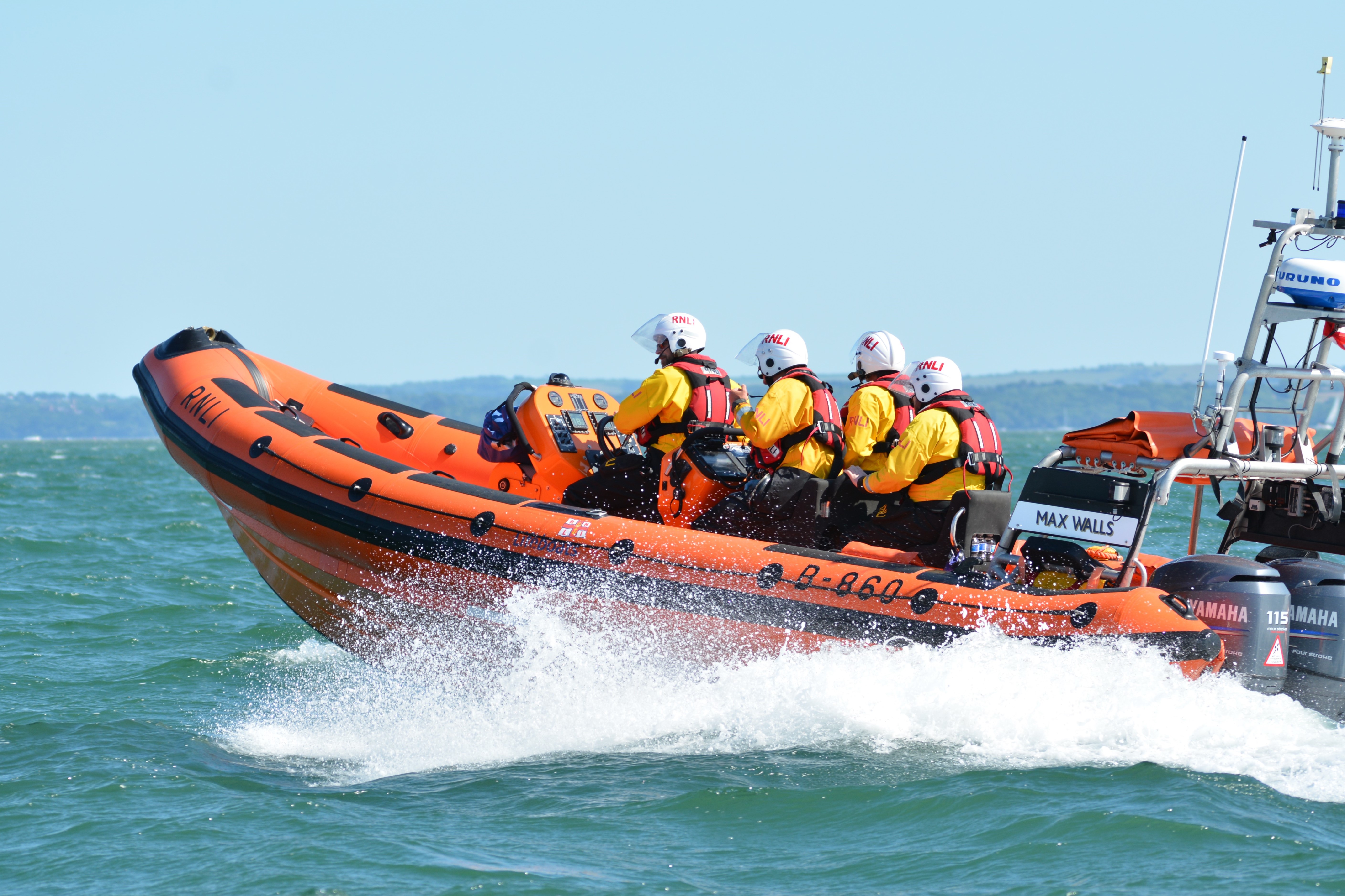 Photo of the Calshot lifeboat 'Max Walls' at sea with four crew on board.