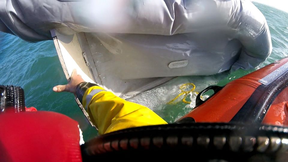 The Selsey lifeboat crew recover the remains of the dinghy