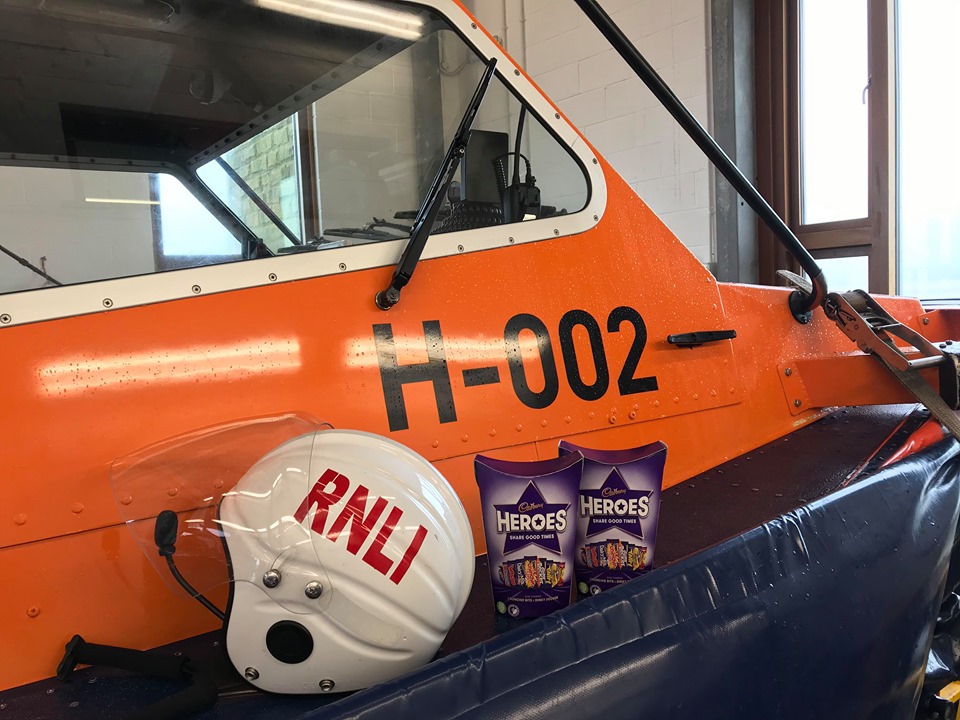 Two boxes of chocolates next to an RNLI helmet on the Hovercraft 