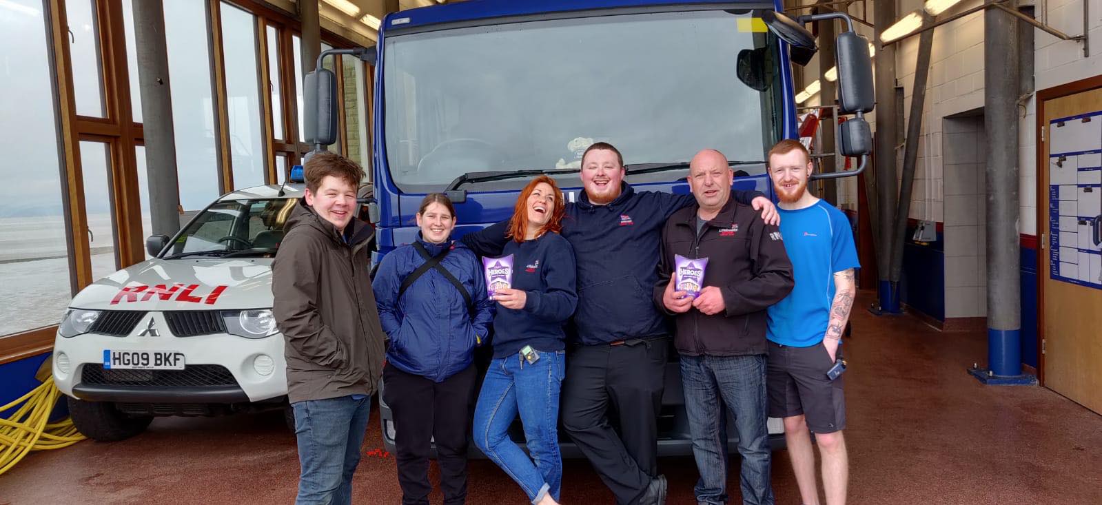 RNLI crew members with the boxes of chocolates outside the station. 