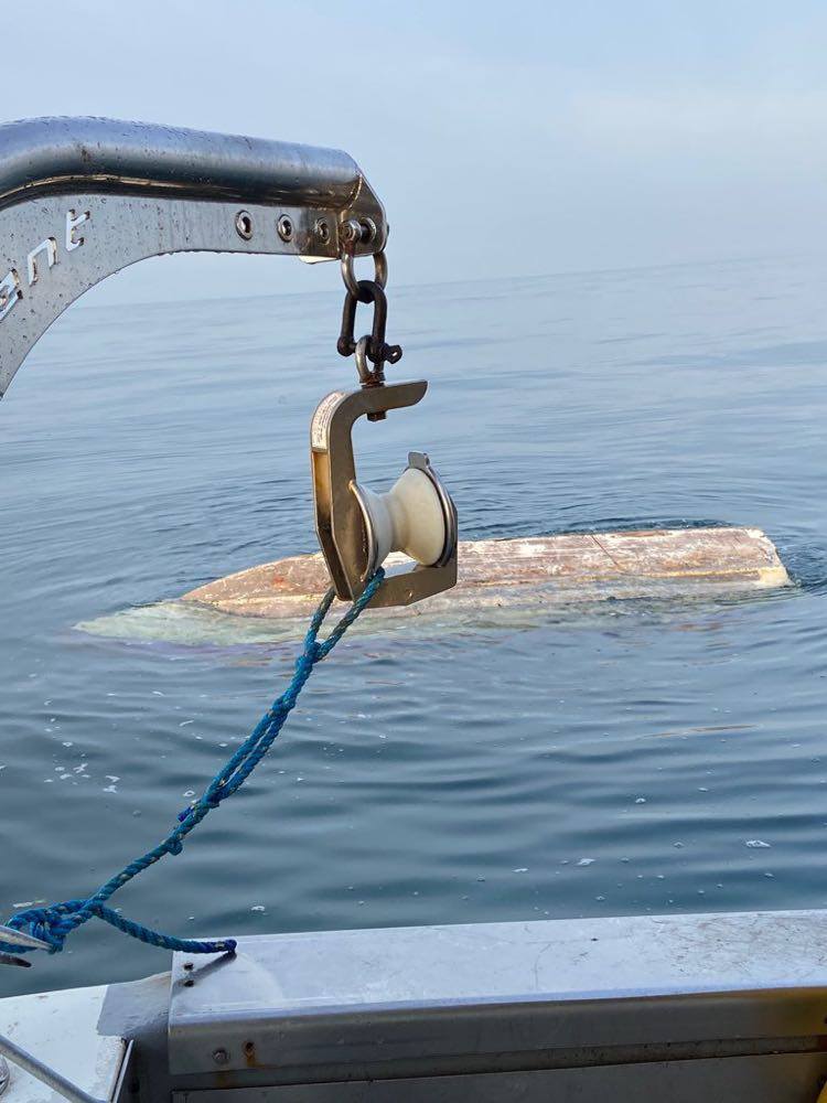 Upturned hull seen from fishing boat