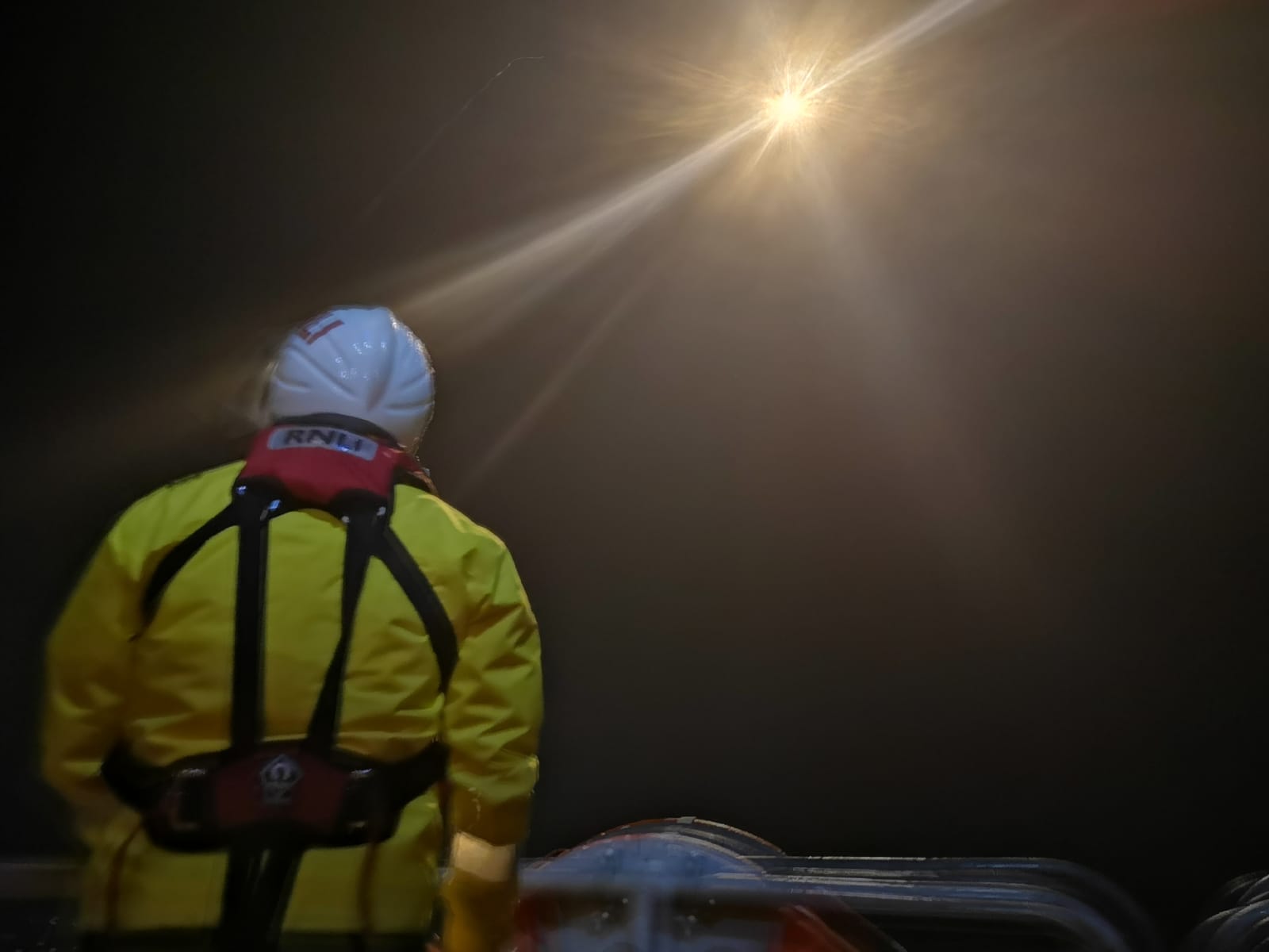 Crew member fires flare for illumination