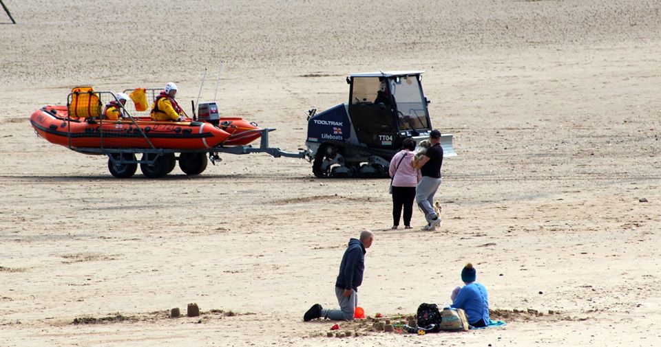 The inshore lifeboat is towed back to the boathouse