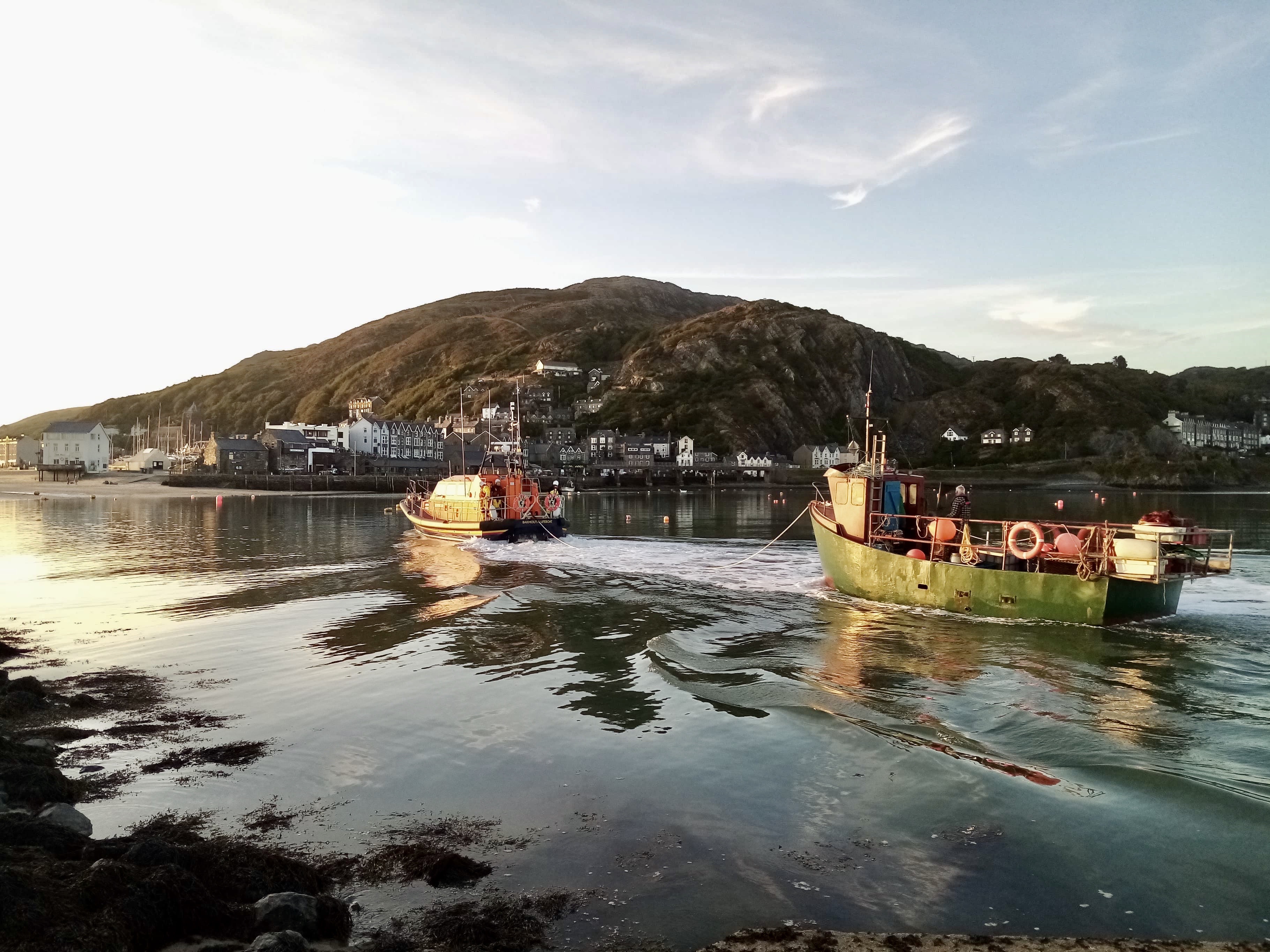 Fishing vessel under tow arriving in Barmouth harbour