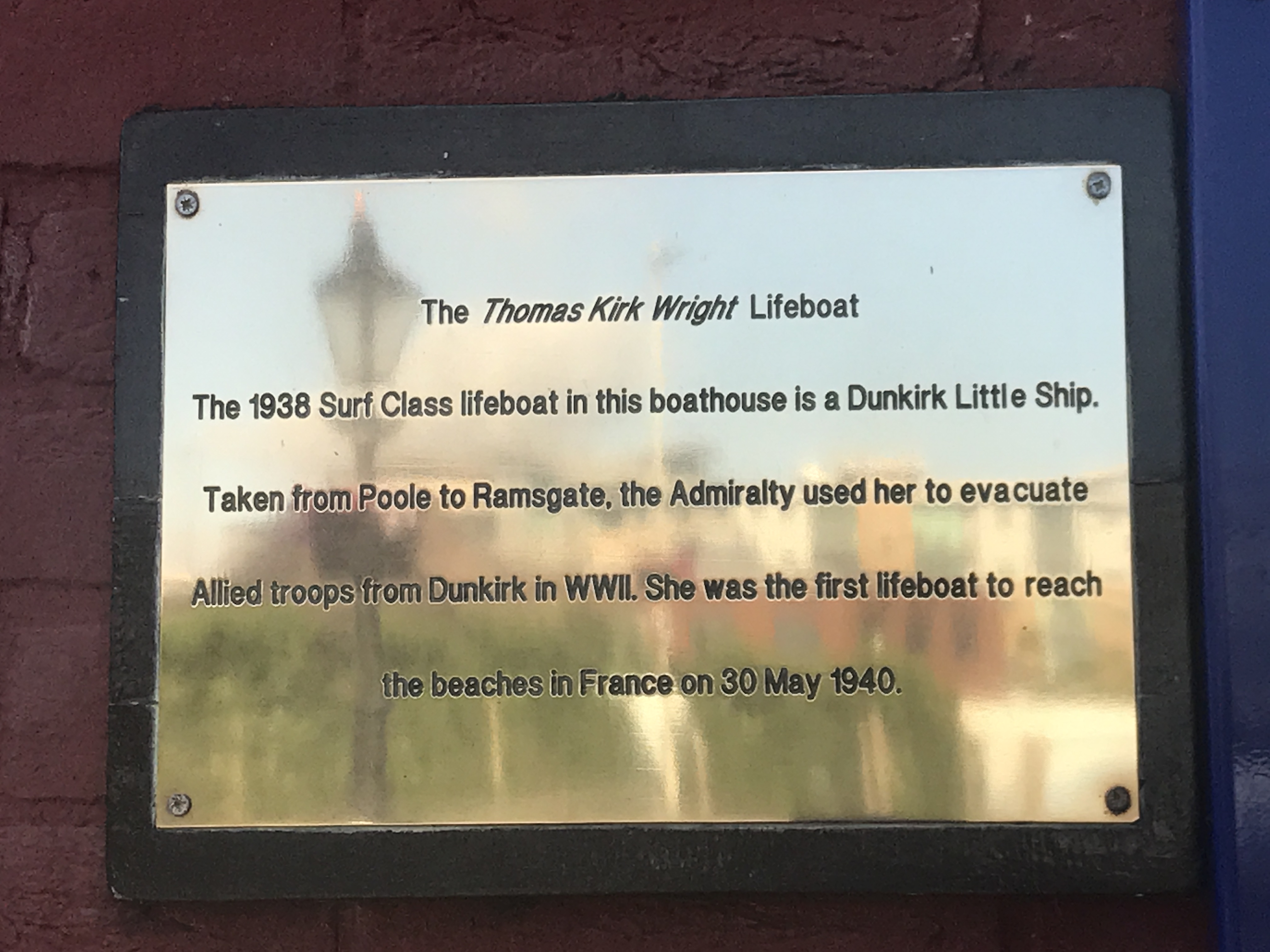 Brass plaque on the wall outside the musueum 