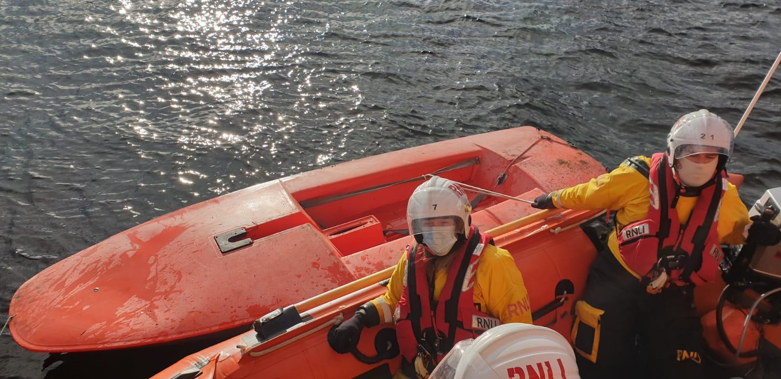 Aberdeen's inshore lifeboat Buoy Woody 85N brings the Topper sailing dinghy alongside, prior to setting up a tow to the lifeboat station