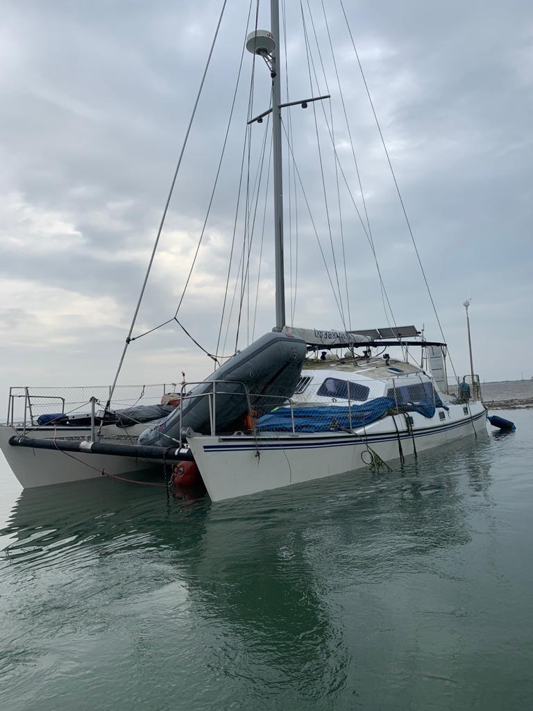 The casualty catamaan is seen from the port (left hand)side with it low in the water due to flooding