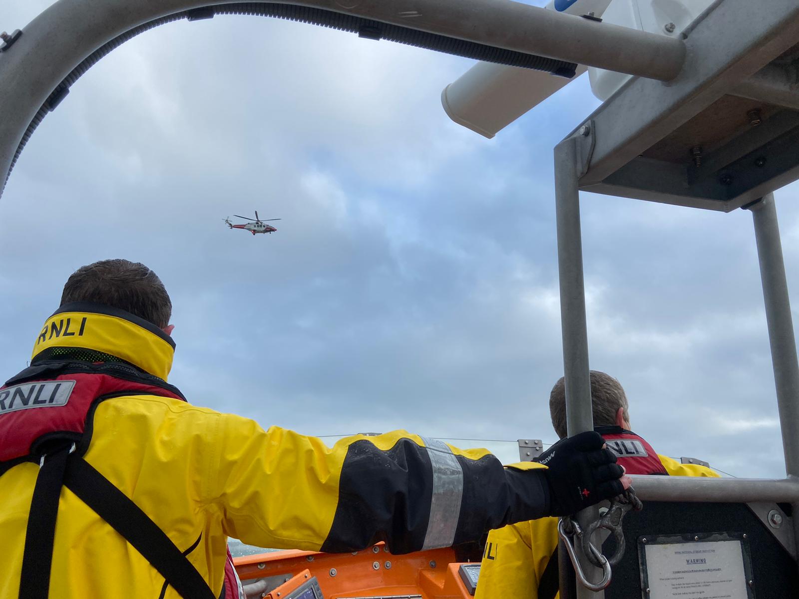 Newhaven Lifeboat volunteer crew in upper steering position search for the missing crew of the 'Joanna C' supported by HM Coastguard helicopter overhead