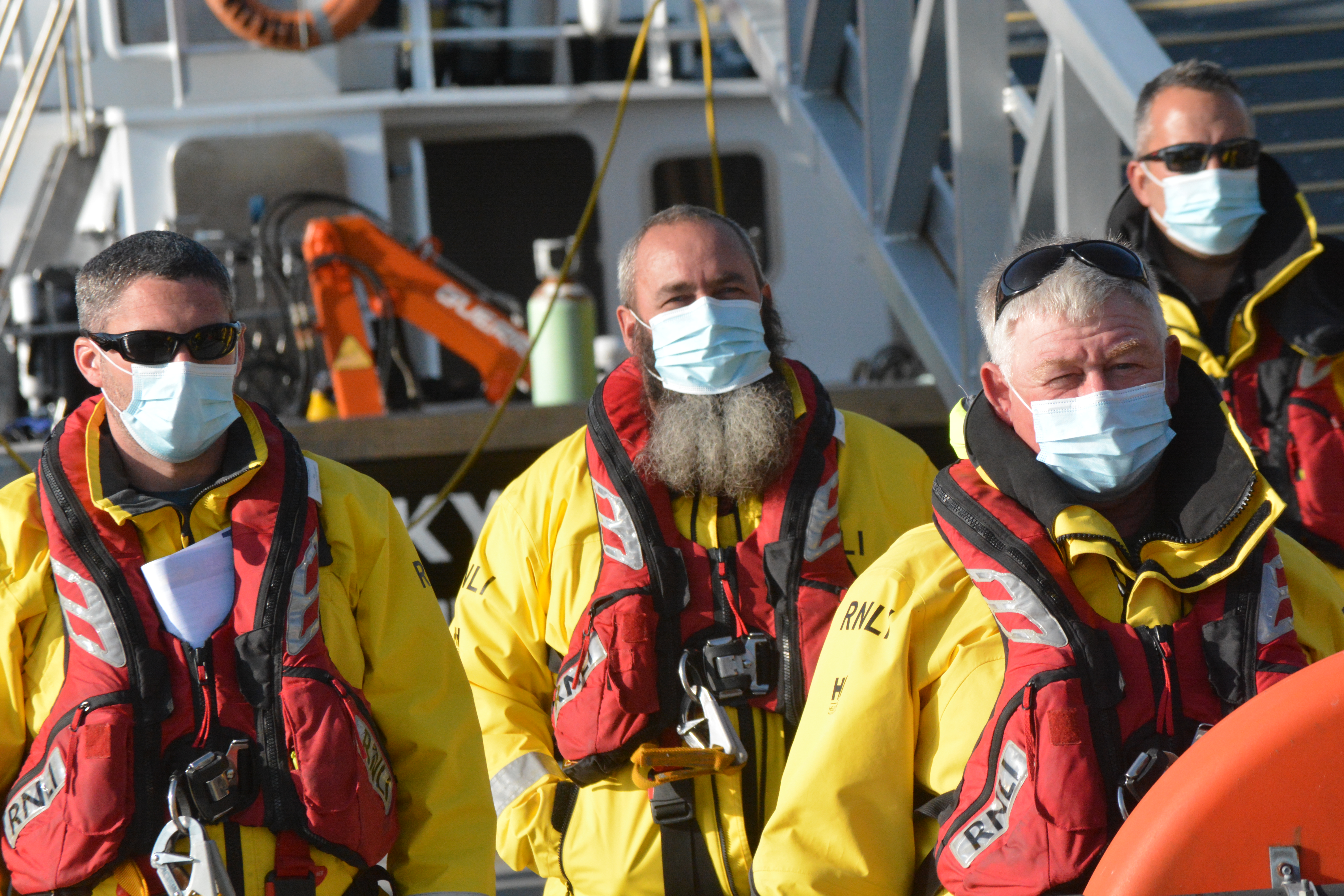 Members of lifeboat crew wearing face masks to protect against covid-19