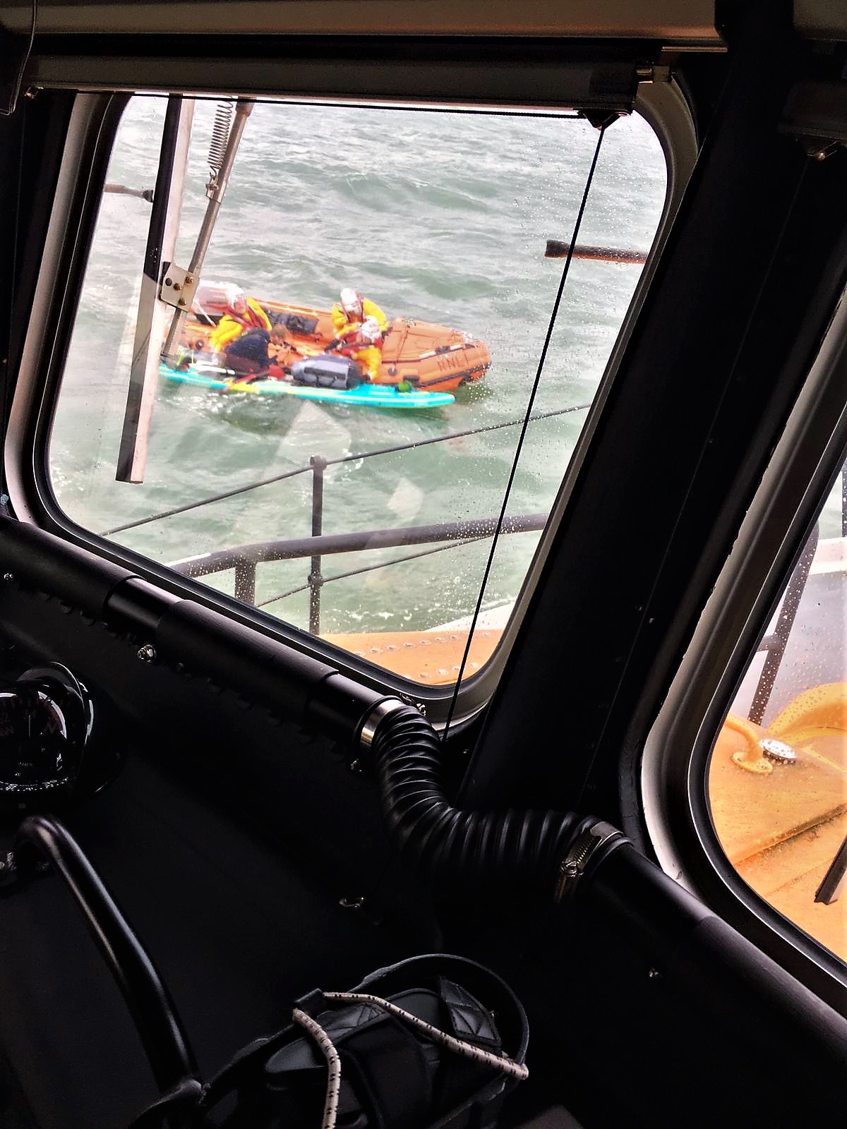 Photo by Aberdeen lifeboat mechanic Cal Reed, taken from Aberdeen's all-weather lifeboat wheelhouse, shows the inshore lifeboat alongside the paddle-boarder, confirming all was well.